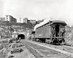 New Jersey circa 1900. "Bergen Tunnel, east end." The Detroit Photographic Special on the tracks. 8x10 inch dry plate glass negative. View full size.
Tunnel VisionHere it is today:
Bergen Tunnel Accident
AboutBergen Tunnel Accident
About twenty years ago, I worked a car fire in that tunnel, as a member of an EMS crew. Most of the passengers were able to walk up the emergency stairs near the Lincoln Tunnel, but there were a few that were injured. We waited in the area where that work shack is in the picture. We transported them as they were brought out on a diesel engine, the power was off in that tube. The other tracks were not closed and the trains came through at speed.
It has not changed all that much since that picture. There is a second tube and it is all electrified now.
Tunnel viewsre: LouK's comment: it's surprising that NJ Transit (the operator since 1983,) let the trains run through at speed while you were evacuating passengers.
Shorpy has a beautiful view of this same train movement at the east end of the Manunka Chunk tunnel.  Of interest to railfans only:  that car, lettered Lackawanna, has M&amp;E in small letters for Morris &amp; Essex.
Silly me!All this time, I thought the DPC Special ran at the end of a regular train, like most private cars. But that would have precluded stopping at will when the light was right or the inspiration struck.
Forget about having to develop your own glass plates! Imagine not being able to pull over to the side at will when you see a good shot! (Unless, like Detroit Publishing, you had the resources to lease your own 4-4-0 American, complete with crew. And possibly [??] signal priority!)
ConductorI know a conductor had other jobs on a train, but I wonder how often he walked through the car and checked Mr. Jackson's ticket?
Bergen Tunnel a.k.a. Lackawanna Tunnel?This "Bergen Tunnel" seems also been called the "Lackawanna Tunnel?" Or is that a mistake, I could find no other source than the caption of the postcard in the link.
I wondered why the portal to the, older, North tube looks so new in the "Tunnel Vision" photo from bluegrassboy, that is because this tunnel has rather recently (starting june 2001) been reconstructed during a performed "rehabilitation program," in order to solve a water leakage problem. If you look carefully you will see that the height has been altered too. That is because:
"It was also essential to improve the vertical clearance in the North Tube to garner a larger air gap between the electrified catenary system and the structure ceiling as well as to accommodate the new double deck passenger cars that [were] being added to NJ Transit’s fleet."
(The Gallery, DPC, Railroads)
