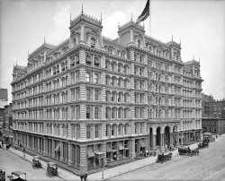 &nbsp; &nbsp; &nbsp; &nbsp; This Second Empire edifice opened in April 1878 as the Working-Women's Hotel, only to close eight weeks later due to an acute case of insolvency. Reopened as the Park Avenue Hotel, the cast-iron marvel at 34th Street lasted until 1924, when it was replaced by an office tower.
New York Circa 1905. "Park Avenue Hotel, Fourth Avenue entrance." 8x10 inch dry plate glass negative, Detroit Publishing Company. View full size.
Re: FocusedThink "f/64"!
There were very good, rectilinear lenses, and with perspective control in the camera, architectural photos could give a true representation of the lines, but to get such clear focus across the plane, it takes a small aperture, and either long exposure or lots of light.
Fourth AvenueFourth Avenue is one of Manhattan's shorter avenues today, extending only to 14th Street. It stops a mile short of where this hotel once stood.  Way back when, however, it ran much of the length of Manhattan and into the Bronx. Starting in the 1850s, the city began renaming the sections north of 34th Street "Park Avenue," the much grander moniker by which it's still known today.
Being located between 32nd and 33rd streets, the Park Avenue Hotel wasn't actually on Park Avenue at all, as at the time the roadway south of 34th was still called Fourth Avenue. One would have to assume that the hotel's owners were eager to latch onto the cachet that even then was associated with Park Avenue.  In 1924, the builder of the office building that replaced the hotel got the city to agree to extend the Park Avenue name two blocks farther south, to 32nd Street, so the building would get the vanity address of One Park Avenue.  It's still around today and still has that address. 
In 1959 the city cut back the Fourth Avenue name still further, renaming the stretch between 17th and 32nd "Park Avenue South." It is Union Square East between 14th and 17th.
Much more about Fourth Avenue here.
FocusedThe lens used for this must have been the best lens in the world in 1905, tack sharp from corner to corner! Better than most people get even now. 
Picture in pictureThese photographs are amazing, but the real jewels are contained within. Zooming in on the main entrance gives you a glimpse of life in 1905, with the guests arriving and departing in their fancy carriages and the baggage handlers on call to the left. Click to enlarge.

Those hatches?Who can identify the purpose of the two propped-open hatches along the side of the building? I first thought they were coal chutes but that didn't seem plausible (wouldn't the building be steam heated from a central supply? And they're too far from the curb)
Ventilators? Maybe... any ideas?
VehiclesAt least one of the fancy carriages appears to be an omnibus, a public conveyance, and may have a regular run from the hotel to a ferry slip or railway stop.  The other two may be for hire as well.  Of course, for those inclined to save a penny or ten, there's always that convenient subway kiosk.
Upon a closer lookIt appears that the carriage drivers are being professionally stoic. The buildings architecture is quite beautiful.
Still Fourth AvenueTo many of us older New Yorkers (even if we no longer live there) it is Fourth Avenoo, not Park Avenue South; just like it is Sixth Avenoo, not Avenue of the Americas.
Today&#039;s ViewThis view is from my office window, looking north up Park Avenue.  The building directly across from my window is the current One Park Avenue, which replaced the Park Avenue Hotel.  It was quite a jolt to see the hotel photo on my computer screen and realize I was actually looking out the window at it's replacement!
(The Gallery, DPC, NYC)