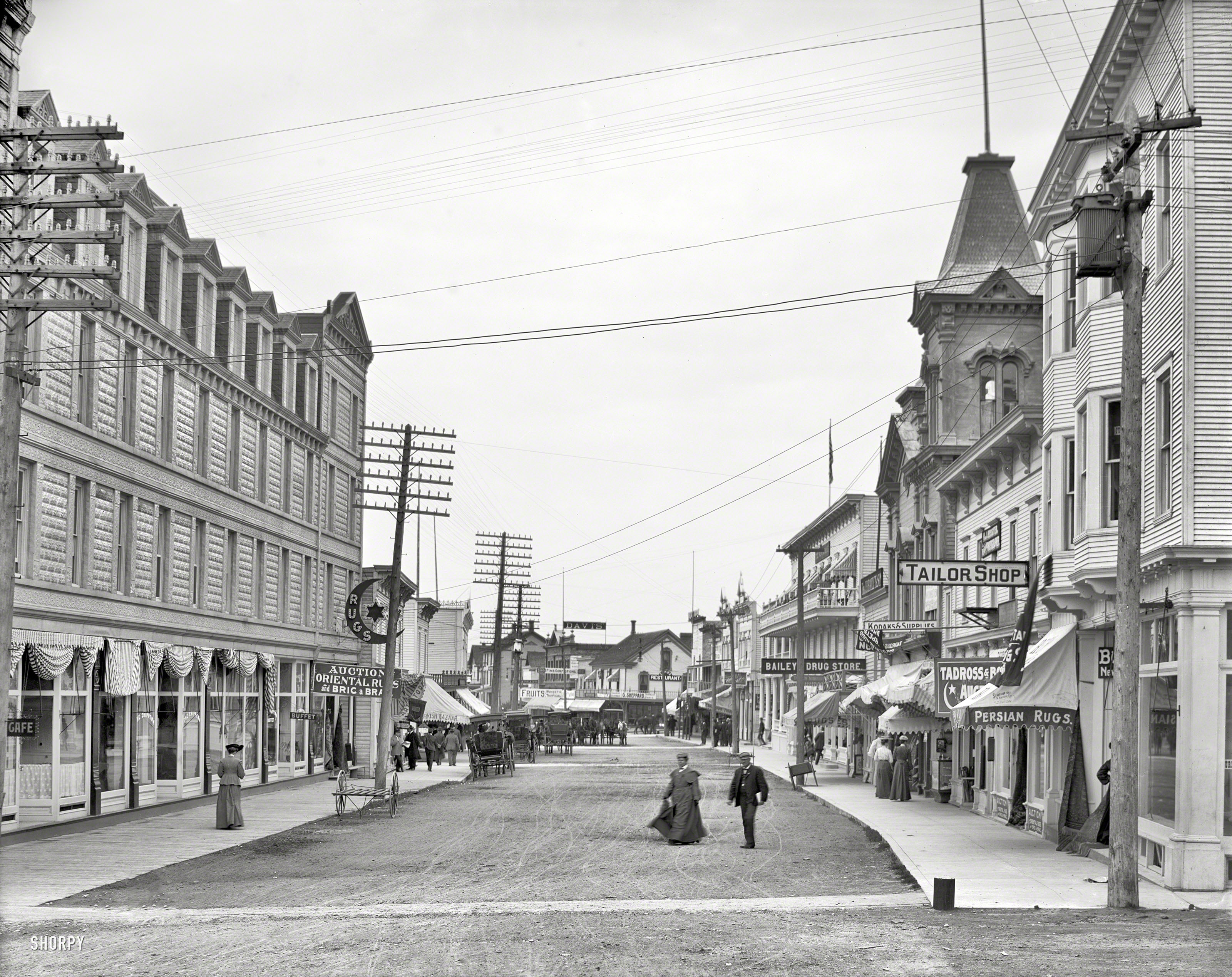Circa 1905. "Main Street -- Mackinac Island." Where pedestrians may avail themselves of Bailey's, a Buffet, Bazaar and Bric-a-Brac. View full size.