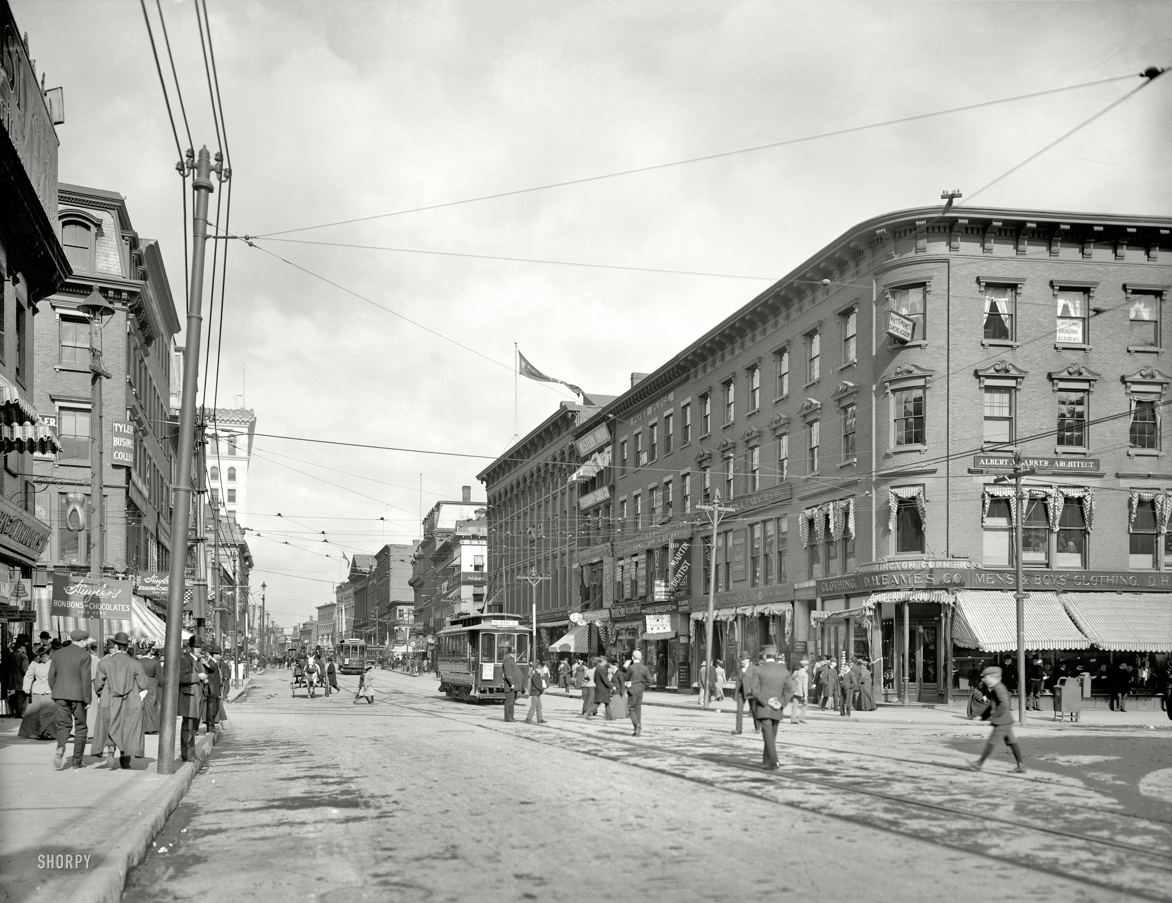 Circa 1906. "Main Street, Worcester, Massachusetts." Bonbons and dance lessons are among the goods and services on offer in this bustling burg. View full size.