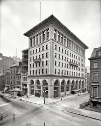 New York circa 1906. "Gorham Co. building, Fifth Avenue and 36th Street." New headquarters, designed by Stanford White, of the noted silver-making concern. 8x10 inch dry plate glass negative, Detroit Publishing Company. View full size.
Stanford White&#039;s artistry &amp; the little building alongsideOne is struck by the masterful detail of White's building: on the lower floors; near the top and on the roofline.
But one can't help but notice the work-in-progress on the attached building. What is it, 25 feet wide and several floors? Well at least they constructed a sort of pedestrian protective walkway! In the Manhattan of recent decades these go on for entire blocks.
More construction picsLove this building. Great proportions and not too heavy on the wedding cake clutter either. But it's the building under construction next door I dig. Wish there were more of these old construction photos somewhere to view. Methods, materials, tools.
SurvivorMost of the Google Street Views that I see posted are in vivid colour. For a change, I thought I would send in the present day view in black and white. Perhaps a new Shorpy category: "Decolorized"?
Modified and Modernized in 1960Architect Herbert Tannenbaum tried to persuade the owner to retain the original design. But, Mr. Tannenbaum said, "They told me 'Do it or we'll get someone else.' " More here.
ProportionsThis is a very precise and exquisite building.  I like the upper two stories with their larger scale windows and that wonderful cornice.  It looks like it extends out a good  or 8 feet from the face of the building proper. I'd love to see a shot from the other side to see how he handled the cornice line along the shared property line.
Sad to see what's happened to the lower floors; wonder if the arches are still there waiting for someone to let them be seen again.   
Up In The BalconyI thought it was interesting that despite some of the changes to the facade of this great building, the two balconies on the front and side still remain. I couldn't quite make it out in street view, but I am guessing that the "G" monograms are still there as well.
Hear that sound?Its Stanford White spinning in his grave. That poor, beautiful building didn't survive the "updated" facade treatment of the tasteless 50s/60s/70s. "Hey, hand me the angel stone."
&quot;Look, Ma&quot;No nets.  No harnesses or hardhats, either. A fellow better pay attention up there, because that first step's a lulu!
The stonework on the building is truly wonderful, though. I'm glad to see that it's still around, but I can't stand the facade it now wears!
WorryWhy should I worry? It is over 100 years ago. But if the man in the middle steps off the plank, the man on the right is toast. Elementary physics. Health and safety eat your heart out. Enough material here for a convention. 
DormersWhat I like is the shape of the dormers in the roof of the Decorators &amp; Woodworkers firm called "B.F. Ruber &amp; Co." (or something like that).
Master Craftsmanship on DisplayThe beautifully pragmatic Gorham Co. manufactory and offices, located in Providence, provide the perfect complement to this eloquent tastemaker in NYC. I’m sure several associated personnel felt as if they had lived and gone to heaven. I can barely imagine the joy of traveling from one location to the other.
(The Gallery, DPC, NYC)