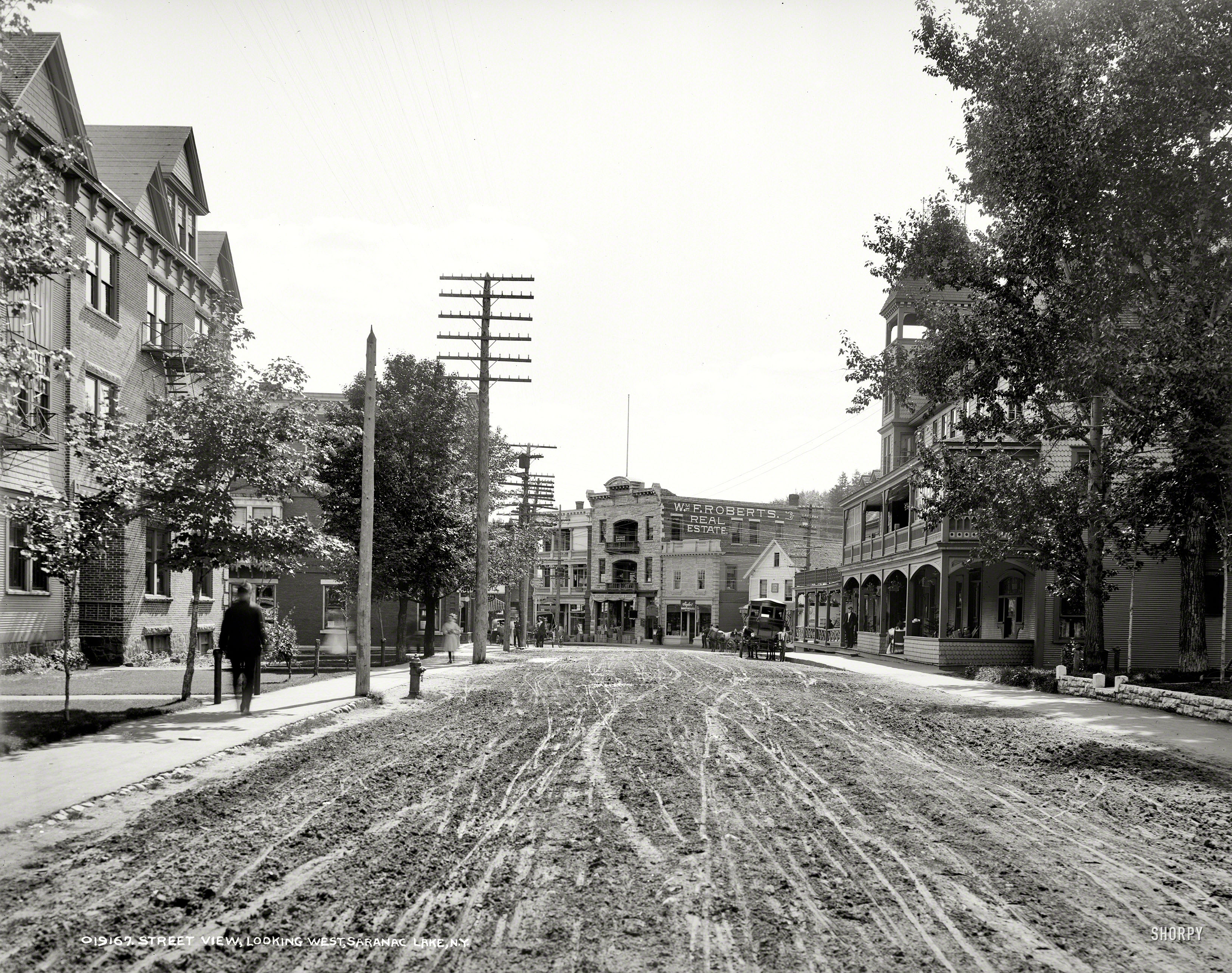 Circa 1906. Saranac Lake, N.Y. "Street view looking west." Back when the Google-Wagon used glass negatives. 8x10 inch dry plate. View full size.