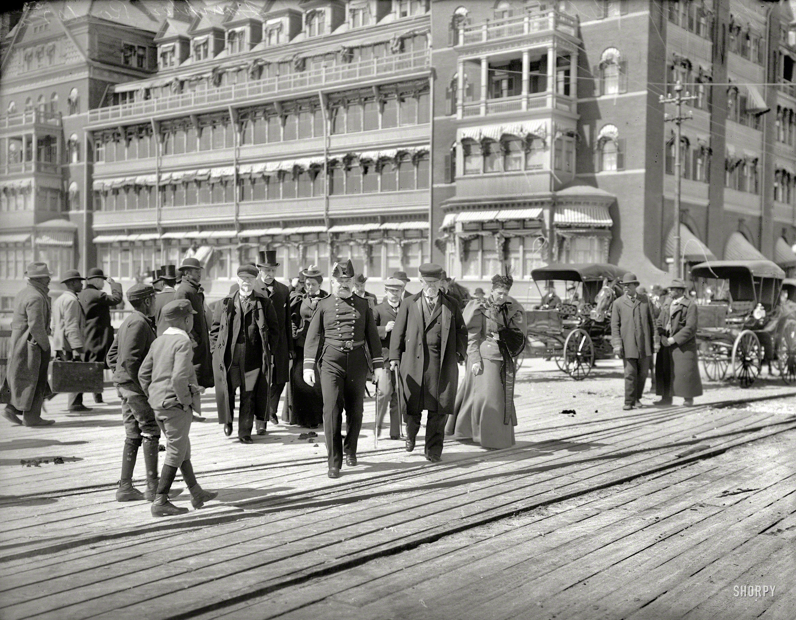 Hampton Roads, Virginia, circa 1900. "Going to the landing stage. Hotel Chamberlin in background." Although the harbor might not be mined, the street is. 8x10 inch glass negative, Detroit Photographic Company. View full size.