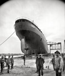 October 1905. Ecorse, Michigan. "S.S. William G. Mather -- stern view before launch." Our second look at this freighter on the ways at Great Lakes Engineering Works. 8x10 inch glass negative, Detroit Publishing Company. View full size.
Long-lived shipRoamed the Great Lakes for 91 years; scrapped in 1996.
The First SS William G. Mather was built by Great Lakes Engineering Works for Cleveland Cliffs Iron and delivered in October, 1905. The Mather was renamed the J.H. Sheadle in 1925, then the H.L. Gobeille in 1955, and finally the Nicolet in 1965. She was scrapped in Port Maitland, Ontario in 1996.
The second SS William G. Mather was also built by Great Lakes Engineering Works for Cleveland Cliffs Iron. She was delivered in July, 1925 and is now a museum ship in Cleveland, Ohio.
That thingWhat is the object protruding from the rudder at the 11 o'clock position?  
That thingIs a turnbuckle for lifting.
Actually that thing......is a shackle, not a turnbuckle.  Shackles are used for lifting, towing, etc.  Turnbuckles are for removing slack from or connecting rods and cables.
(The Gallery, Boats & Bridges, DPC)