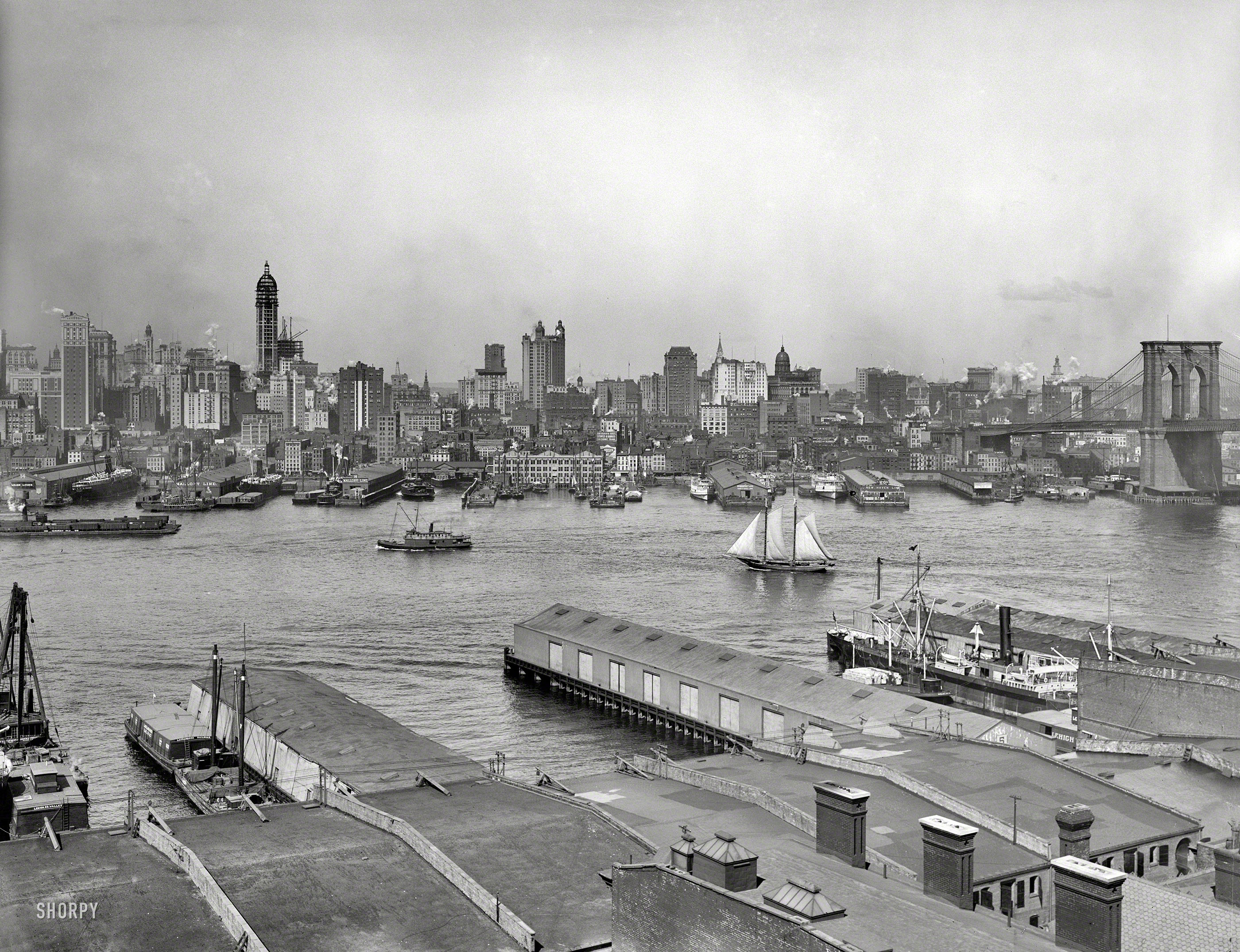 Manhattan circa 1907. "The heart of New York from Brooklyn." A continuation of this view across the East River. Landmarks include the Singer Building under construction, the Park Row building and Brooklyn Bridge. View full size.
