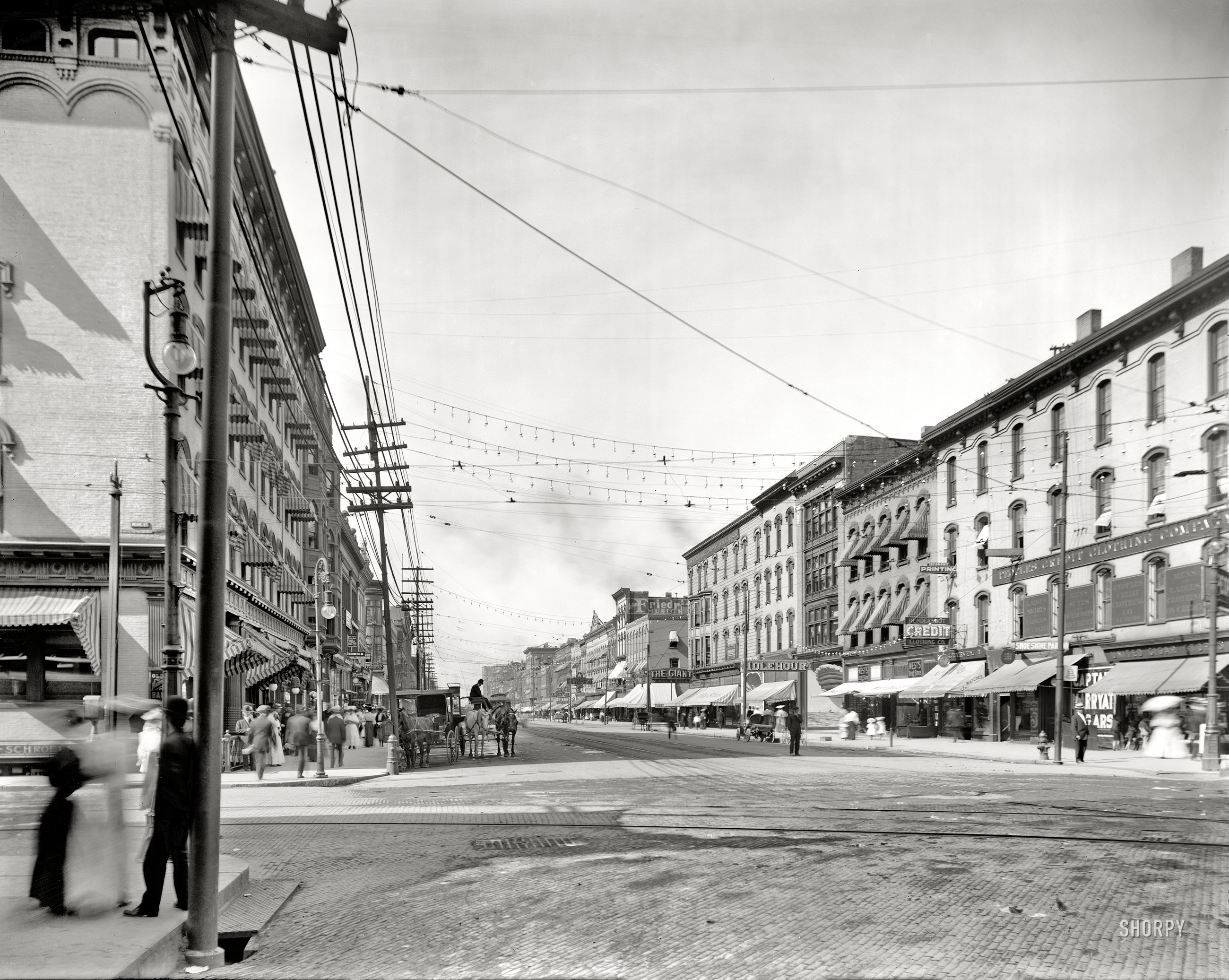 Grand Rapids, Michigan, circa 1908. "Canal Street from corner of Monroe." Merchants vying for your trade include The Giant, Idlehour and People's Credit Clothing Co. 8x10 glass negative, Detroit Publishing Company. View full size.