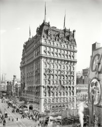 New York, 1909. "Knickerbocker Hotel, Broadway &amp; 42nd Street." Decked out for the Hudson-Fulton Celebration. 8x10 inch glass negative. View full size.
A-bunting we will go! Wow!  When they decorated for a festive occasion back then the did it right. I wonder how many yards of flag bunting they used on that building? 
Most of the subway entrances of that style were removed ages ago, but few of them still remain scattered around midtown Manhattan. 
The building is still there, but no longer a hotel. Built by John Jacob Astor as a showcase of luxury in a time of economic prosperity in the city, the hotel was destined to close its doors only 15 years later due to changes in fortune. The building was later home to Newsweek magazine from 1940 to 1959, and after major renovation in 1980 it is now used for garment showrooms and offices.
Darn You Shorpy, Darn YouAnother two hours of my life gone! Spent browsing the gorgeous detailed photos on this site, viewing the high-def images, marveling at the detail, enjoying the historical aspect of the photos, and even reading and enjoying the comments. It's a good thing I'm retired so I don't feel too guilty spending all that time here. I've been visiting here over 3 years now, and yet every visit is like finding a new treasure. You're still the best site on the web!
EnvyIt appears a woman crossing the street was caught in the act of admiring the other woman's attire. Boy glad that's not done anymore!
Oh, if i could just reach in!Our theater company is mounting the musical "Ragtime" this season. I have had to source out the material for our custom-made bunting -- yards and yards of red, white and blue (and white stars). Wouldn't it be nice if I could just ... sigh!
HF?Who/what would "HF" represent on the flag? BTW, we get to see the subway and the elevated in the same frame. Cool.
[Perhaps the caption contains a clue. - Dave]
ETA: Yes, Dave, I think it does. lol. How did I miss that?!? And there I was, thinking it might be Hill Figger. Go figure.
Going DowntownWe get a good view of the original subway entrances on the corner.
Cheers!One of the legends about the original Knickerbocker Hotel comes from the drink called the martini, which was said to have been invented by the house bartender, Martini di Arma di Tagga. In 1912, he mixed dry vermouth and gin together and the mixture gained the favor of John D. Rockefeller, who liked it so much that he recommended it to all his Wall Street buddies, and the drink quickly became a national favorite. Another remnant of the past is a sign for the hotel that can be found in the New York City subway. The “Knickerbocker” sign is posted over a doorway that once connected the hotel to the east end of the platform for Track 1 of the 42nd Street Shuttle.
Two by TwoWhy two subway entrances on the same corner?  Entrance vs exit? Two different lines?
[One for each direction -- they're marked Uptown and Downtown. - Dave]
The Edison CompanyIn mid-block we see a sign for some offices of The New York Edison Company, the local electric utility for Manhattan. My father started work with the The Brooklyn Edison Company in 1928 and a few years later most of the NYC utility companies merged to form what is still known as Consolidated Edison (ConEd).
CoincidentallyToday's Wall Street Journal has an article about a Texas-based group looking to turn the building back into a hotel.
The U.S. FlagThe photo is dated 1909 but the flag on the hotel is a 45 star flag which was replaced in 1908 when Oklahoma became a state.
[Not this one. -Dave]
Scandalous! Really! I never.
The amount of skin showing on that Woman in the Advertisement across the street is simply ruinous to impressionable young minds!
The New Dressler?I just finished reading the book Martin Dressler by Steven Millhauser.  This photo of the Knickerbocker is exactly what I imagined one of the hotels described in the book looking like.  Wonderful detail and easy to get lost thinking of what's inside.
[The cover of the book shows the Hotel Astor decked out for the Hudson-Fulton celebration. Note the ship's prow over the entrance.]
O.J. GudeIn 1878 with $100 in capital the O.J. Gude Company was founded and goes on to pioneer the first use of the electric bulb in a billboard sign in May, 1892 just thirteen years after Thomas Edison invents the first light bulb.
More Info from the great great grandson of O J Gude.
(The Gallery, DPC, NYC)