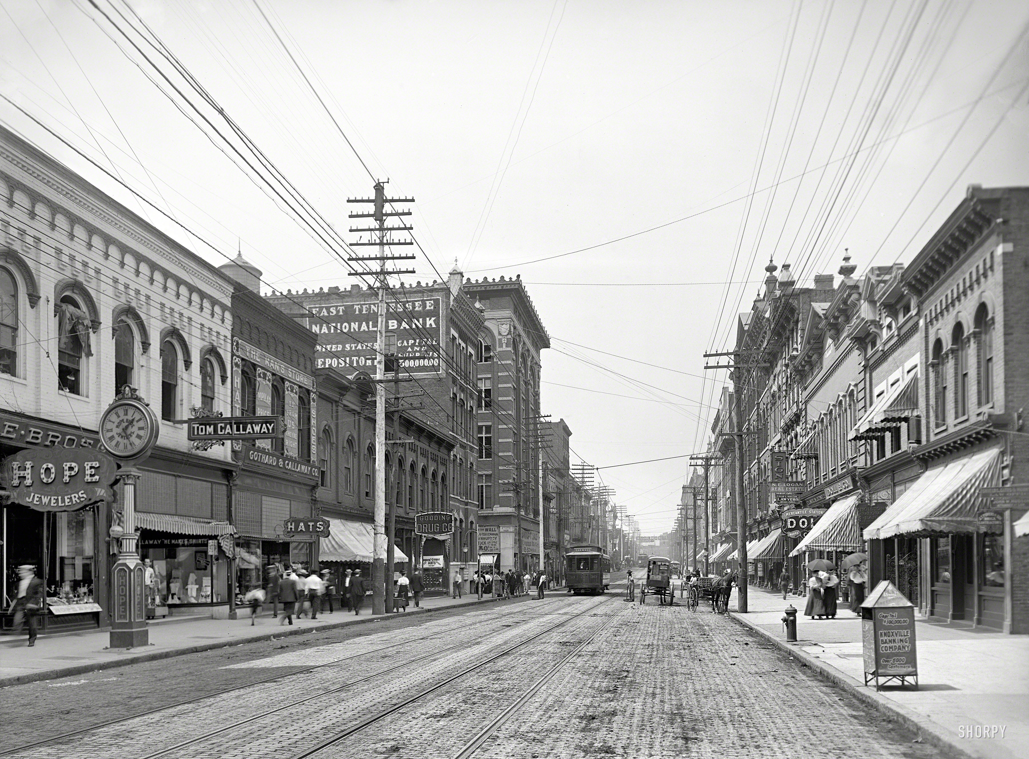 Knoxville, Tennessee, circa 1905. "Looking north on Gay Street from near Clinch Avenue." A pulsing commercial artery where Hope Jewelers, The Man's Store and East Tennessee National Bank are among the businesses vying for your trade. 8x10 inch glass negative, Detroit Publishing Company. View full size.