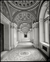 Circa 1908. "South corridor, Library of Congress, Washington, D.C." 8x10 inch dry plate glass negative, Detroit Publishing Company. View full size.
Amazing ArchitectureWe have more technology today, yet we can't seem to produce this kind of architectural beauty.
HopefullyIt hasn't changed, just mellowed with time.  Wonderful picture; great details.  
Still BreathtakingAfter being defiled by government bureaucrats for several decades, a dozen-year restoration was completed in the late 90's.  Once again it is what some have called the most beautiful interior space in the US.
When friends and family ask me for DC sightseeing recommendations, I always put the Library of Congress at the top of the list.  Most had never considered it.
Not TechnologyIt's not the technology that keeps us from producing architectural beauty of this sort, it is a lack of desire on the part of clients to have such architectural ornateness. Most clients want a utilitarian functionality which means there is no place for "unnecessary" details that might distract workers from their work.
Just as an example the city where I lived is going to build a new art gallery. It is going to be a square soulless box. The architects - who have obviously never heard of the Guggenheim Museum - stated that the building has to be a box because you need flat walls to hang the art on.
What kind of glass?I'd love to know what kind of lens the photographer had on his camera. He obviously had the camera pointed straight down the hallway, but the detail from floor to ceiling is nice and crisp. (I'm thinking it was an early wide angle lens)
The murals above the doorway, left, and the doorway at the end of the hall are clear enough to make out (even to my tired old eyes) as are the smaller triangular portraits in the groins of the arches above.
I'd love to get back to D.C. and find this hall just to photograph it as it is today with my digital camera and 24mm lens, set to Black and white. Then, I would put the two photos side by side for comparison. 
(The Gallery, D.C., DPC)
