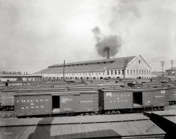 Circa 1904. "Chicago &amp; Alton Railroad shops at Bloomington, Illinois." At left rear, the Anheuser-Busch beer boxcar. 8x10 inch glass negative. View full size.
GraffitiI like the graffiti on the side of the train. People were doing that even back then. Interesting.
[The chalk markings are from the yard crews, noting such things as routing, special content advisories, repairs required, etc. Often seen on rail yard photos here on Shorpy. -tterrace]
C&amp;A Blues"I said, let me tell you, peoples
What the C&amp;A will do for you
Well, now she will take yo' little woman
Then will holler back at you..."
From The C&amp;A Blues, by Peetie Wheatland, circa 1930
No DumpingThe old shops are gone, you can still see the foundations on Google Earth at
https://goo.gl/maps/BQFNq
It looks like there may have been a turntable just to the south of the main building.
Also, the shops can be seen in an old postcard on the Wikipedia page for the Alton Railroad at
http://en.wikipedia.org/wiki/Alton_Railroad
There is no good street view of the site, the road stubs leading into the site all have the same sign: No Dumping.
(The Gallery, DPC, Railroads)