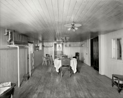 New Baltimore, Michigan, circa 1901. "The Firs -- dining room." This house's amenities included radiant heat, Edison lamps and much wood. Bon appetit!  8x10 dry plate glass inch negative, Detroit Publishing Company. View full size.
The FirsI grew up in New Baltimore. The Firs was briefly a bed and breakfast at some point. It was built for the Hathaway family. New Baltimore is on Lake St. Clair. Sadly, the mansion was torn down several years ago. 
Plenty of Elbow RoomLooks a bit sparse.  Wonder what the wait time is?
Heat RisesSomeone put the "radiant heat" a bit too high up.
Hathaway HouseOr Hatheway House. Eitherway, house reputed to have been haunted.
Steamed UpApparently the radiator is set high because of the level of the boiler. The condensate water must drain back to the boiler, no pump in this system. Better than no heat at all.
&quot;Dinner is served&quot;in the  "Low Head Room"
I don&#039;t know whyBut this room reminds me of the inside of a caboose. Glad to get the comment from CharlieB, because we have seen a lot of elevated radiators in Shorpy pics and I have been curious as to why they would be that high off the floor.
The Dutch DoorAnd other charming touches, the dinnerware displayed on the wall, the window seat, the pretty little casement on the near right, the rustic floor make this an inviting and cozy room in which to dine!  Bet it smells good in there, too!
The FirsTo my understanding that basement room was once a speakeasy. I have been in that home as back in the early 2000's when I bought a whole basement full of ceramic molds there. A family had bought it and was in the process of redoing the house. It still had all the original woodwork. All the basement rooms were said to have been used as ladies-in-waiting areas. My husband went up in the widow's walk. It was a really beautiful home in need of a lot of care.
(The Gallery, DPC)