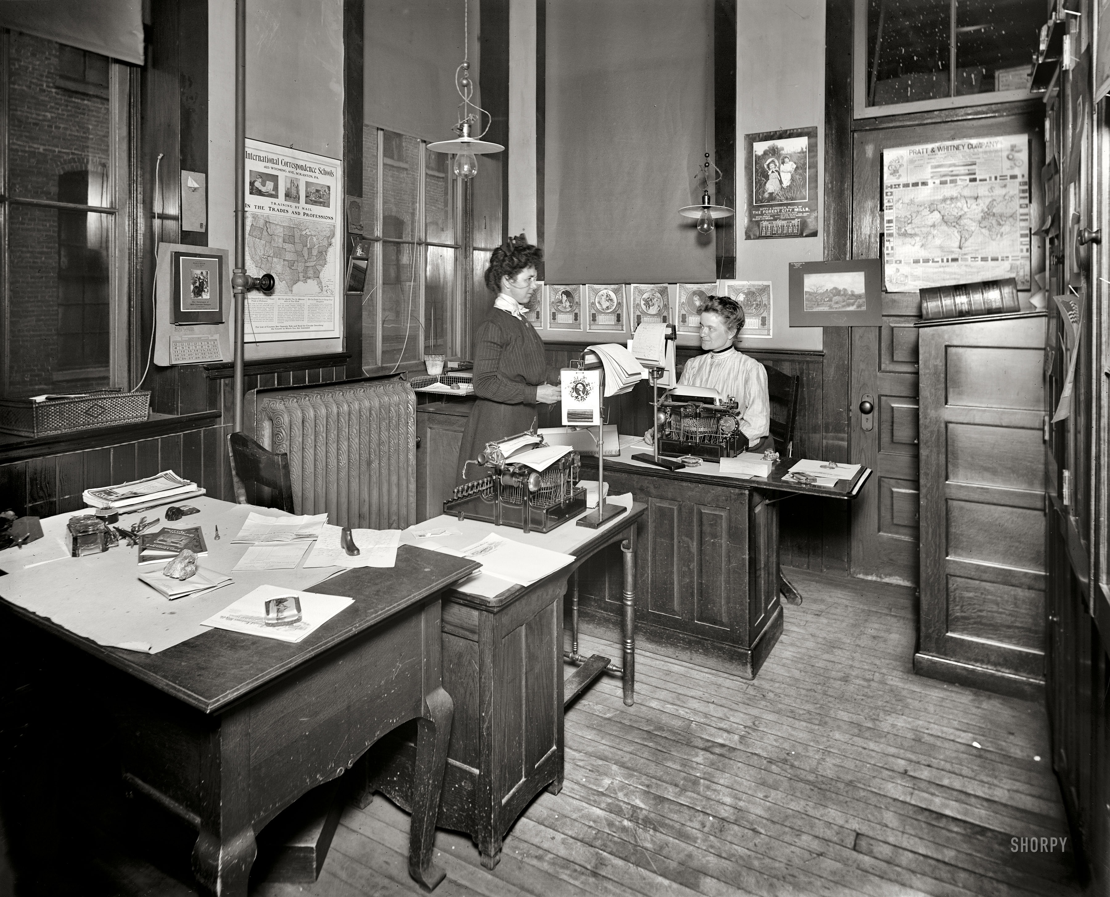 "Stenographers' room, Leland & Faulconer Manufacturing Co., Detroit." It's always helpful to have a calendar in the room when dating a photo, and here we've hit the jackpot. In fact the main focus of this room seems to be calendars, with paperweights a strong second. These ladies ran a tight ship, with little doubt as to what year it was or whether that crucial report might go sailing out the window. 8x10 inch dry plate glass negative, Detroit Publishing Company. View full size.