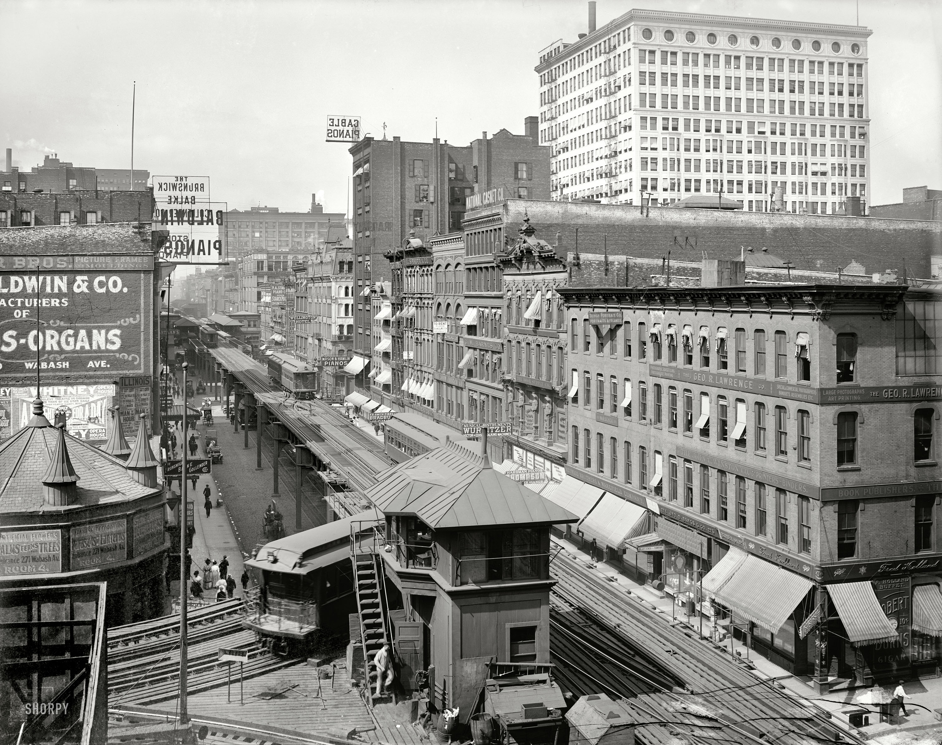 From 1907, a bird's-eye view of Wabash Avenue in Chicago, showing the celebrated "El," or elevated railway, as well as a number of piano manufacturers and the National Casket Company. Detroit Publishing Co. View full size.