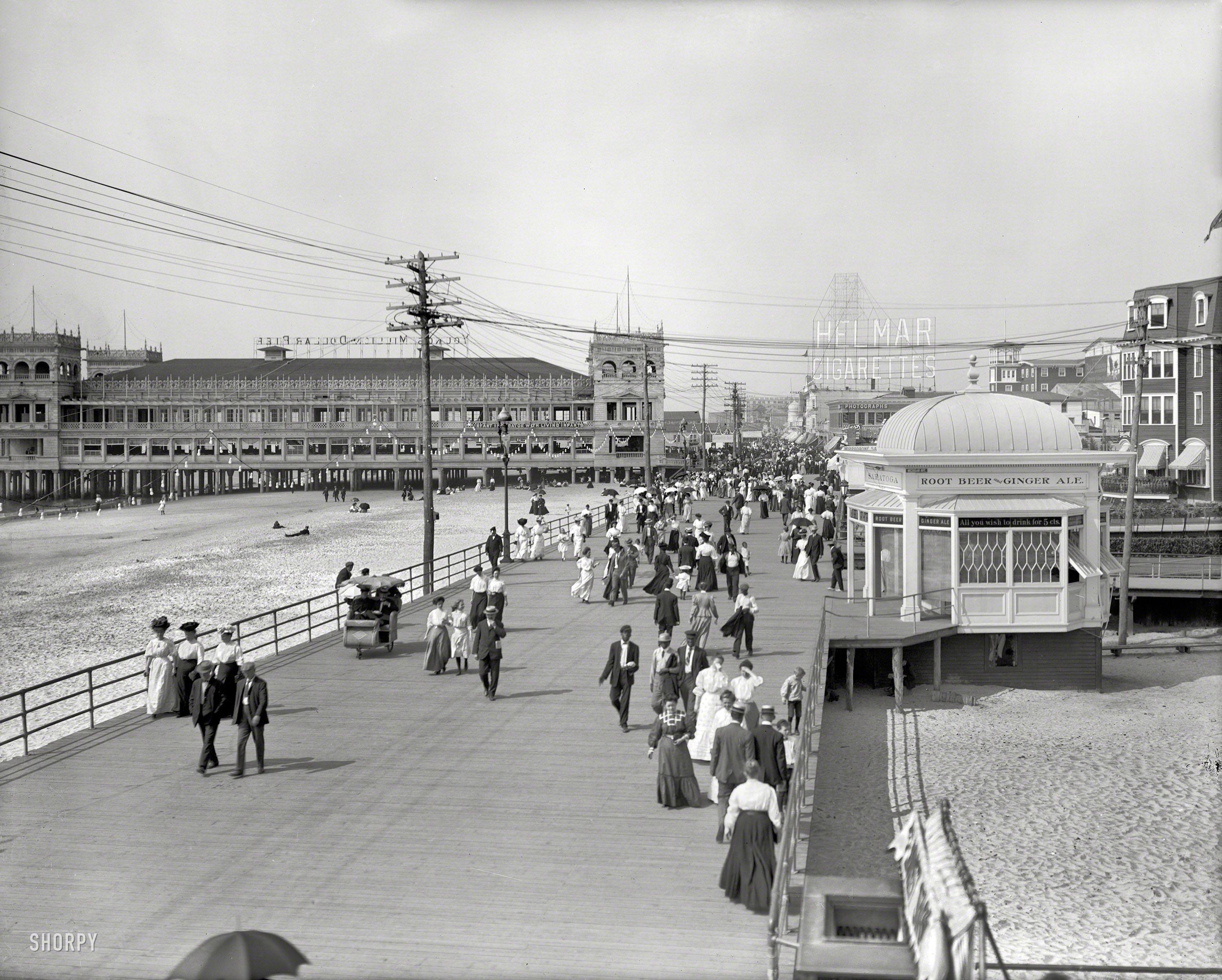 The Jersey Shore circa 1908. "On the Boardwalk, Atlantic City." Advertising signage competes for our attention in this view -- Saratoga Root Beer & Ginger Ale ("All you wish to drink for 5 cts") vying with Helmar Cigarettes and Young's Million-Dollar Pier ("INFANT INCUBATOR WITH LIVING INFANTS"). 8x10 glass negative, Detroit Publishing Company. View full size.