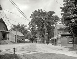 York, Maine, circa 1908. "Street in York Village." Handbill on the tree: GREAT BASE BALL GAMES FRIDAY &amp; SATURDAY, YORK BEACH. View full size.
Broad gauge?That streetcar track sure looks like something broader than the usual standard gauge.  (The overhead trolley wire shows clearly, so at least something electric used the track.)
A Quiet and Peaceful Villageand with just a little bit of work the Post Office could easily have a drive through window.
The trolley tracks...are probably for the Atlantic Shore Electric Railroad. This was an intercity electric trolley line that connected York Harbor to Dover, New Hampshire. On a 1920 topographic map the line's tracks are shown running down the main street in York Village.
We are here, I thinkThe Millinery Shop on the left is now the Old York Historical Society
If you take a left at Lindsey No 2 Rd you will see the little house with the window on the roof.
View Larger Map
Helen Bragdon, MillinerThis one took some work because I couldn't quite read the sign.  From the census it appears that an older Helen, head of household, is a widow, and her 28 year old daughter Helen M is the Milliner.  The 1900 census shows the mother as Georan Bragdon, dressmaker, but the Maine birth records confirm Helen (Weare) as mother and a George Theodore Bragdon as father.
Street Railway GaugeI'm pretty certain the trolley was standard gauge. I live in Pittsburgh where the trolley gauge was 5 feet 2-1/2 inches. It looks much broader than the gauge in this photo.
Home!Finally, after browsing Shorpy daily for 3 years, I see a picture of my home town! I've been down that street thousands of times. That scene is at the intersection of York Street and Long Sands Avenue, right in the heart of "Old York", where there are many restored historic buildings, including the Old Gaol, which is is right behind the buildings on the left of this picture. A 90-degree turn to the left, and you would see the Civil War memorial statue, which bears a striking resemblance to a Confederate soldier. A 90-degree turn to the right, and you would be able to see my grandmother's house.
(The Gallery, DPC, Small Towns)