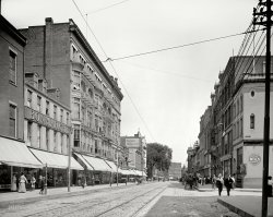 Lowell, Massachusetts, circa 1908. "Merrimack Street looking east." 8x10 inch dry plate glass negative, Detroit Publishing Company. View full size.
Bon Marche(d) into OblivionGoogle Map of this district shows that between then and now a faithfully reproduced extension was added to the building on the left side of the street after the Bon Marche building had been razed.
Quite a few buildings are still standingThanks to the Palmer Street sign, an easy find.
View Larger Map
My HometownI grew up in Lowell. The Bon Marche lasted until at least the late 80's when I was in High School. Their main competitor was Jordan Marsh right next door. One of the two was slightly snootier than the other but I don't remember which anymore. 
We bought all of our school clothes, appliances, gifts, furniture etc at these two stores until the late 70's when a shopping mall with a Sears and a Caldor (and more importantly a giant parking lot) were built just outside town.
Somehow, these two stores managed to keep the lights on for years after the rest of downtown died.
(The Gallery, DPC, Stores & Markets)