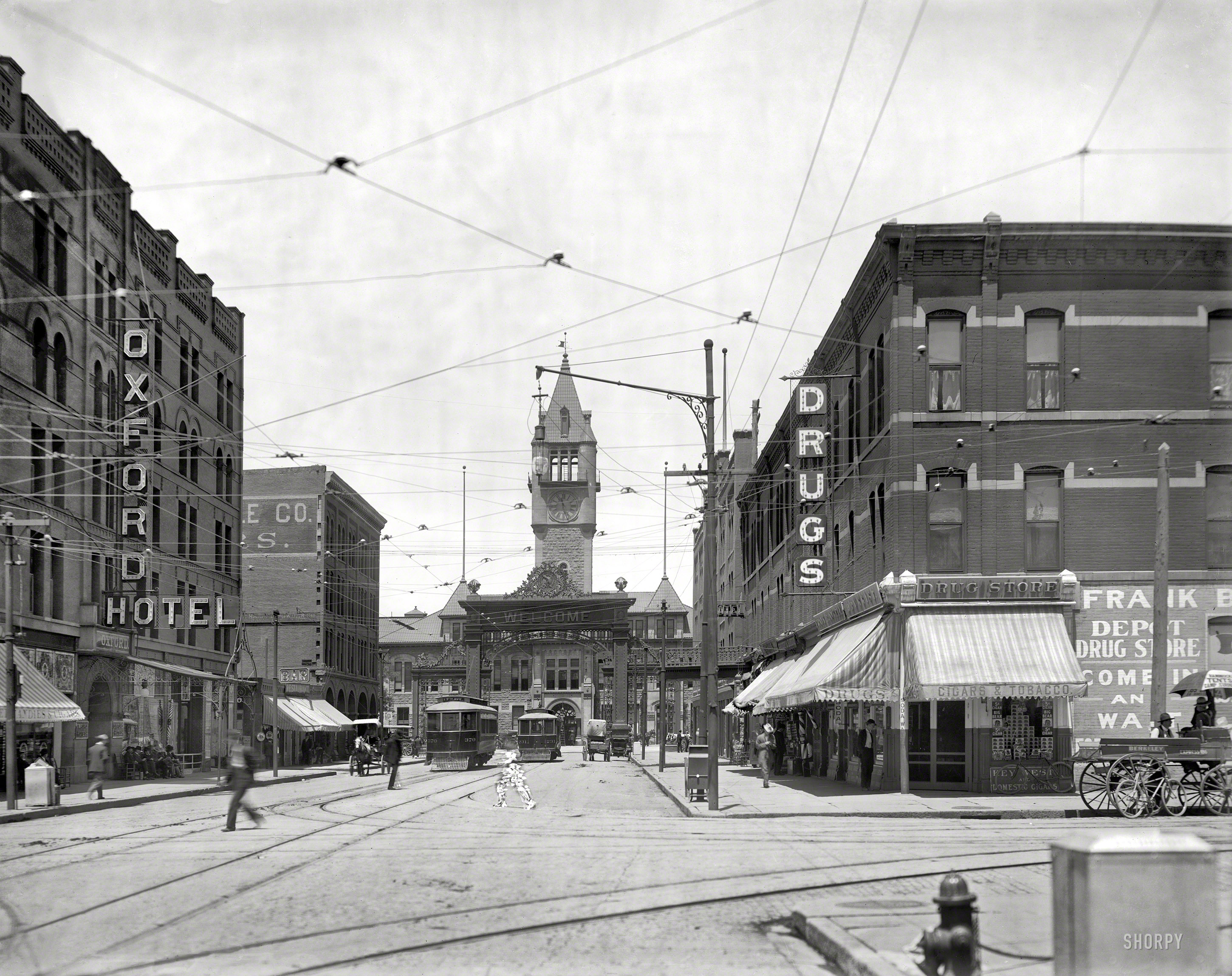 &nbsp; &nbsp; &nbsp; &nbsp; Click here for a view of the arch from the depot.
Denver, Colorado, circa 1908. "Welcome arch and Union Depot." Where blurry pedestrians risk the retoucher's brush. 8x10 glass negative. View full size.