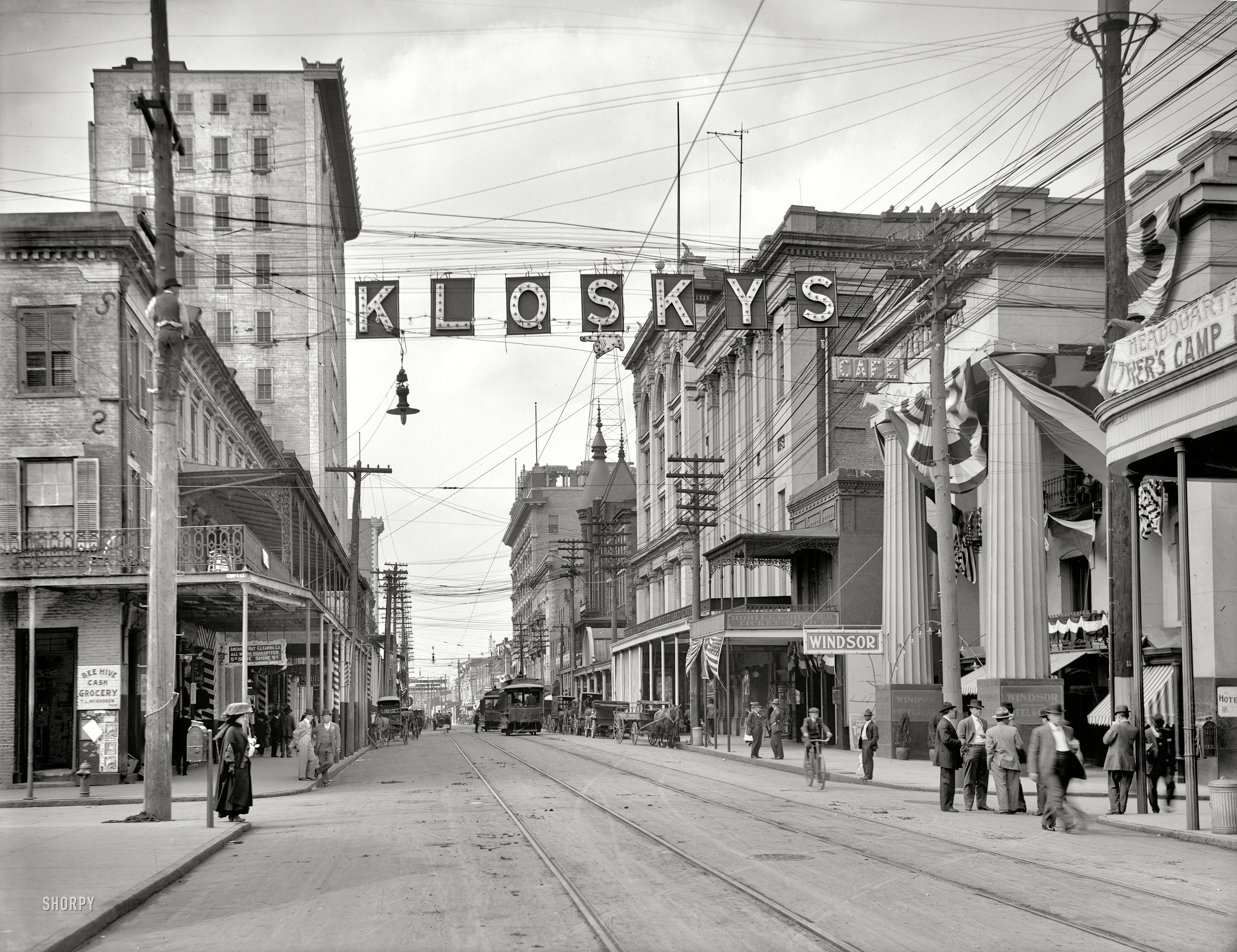 Mobile, Alabama, circa 1910. "Royal Street looking north." Points of interest include a lineman up a pole and the fickle finger of retail. View full size.