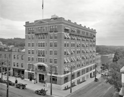 Burlington, Vermont, circa 1911. "Hotel Vermont." Now the Vermont House condominiums. 8x10 glass negative, Detroit Publishing Co. View full size.
Still there at Main &amp; St PaulView Larger Map
RoofI wonder what those two ladies are doing up on the roof.
Sidewalk skylights?I used to work in a department store building that had ones like those in front of Hotel Vermont and remember the distinctive sound and shadows of pedestrians passing by above. I always wondered if they had a specific name, or if they were just known as sidewalk skylights. Though there were many old examples in downtown San Diego at that time (early 1960s) I don't think there are any now.
[Sidewalk skylights are among Shorpy's most popular street scene sightings, joining arc lamps, precarious building-ledge people and drug store rubber goods signs. -tterrace]
A pair of fine-feathered friends....... are roosting on the roof.
Look closelyon the long side of the building for the Hotel Vermont sign( paint or brick?) one floor below the iron balcony, it is visble on both google and the original photo.
Ghostly Maidens on the RoofVisitors from the Overlook Hotel maybe?
(The Gallery, Cars, Trucks, Buses, DPC)