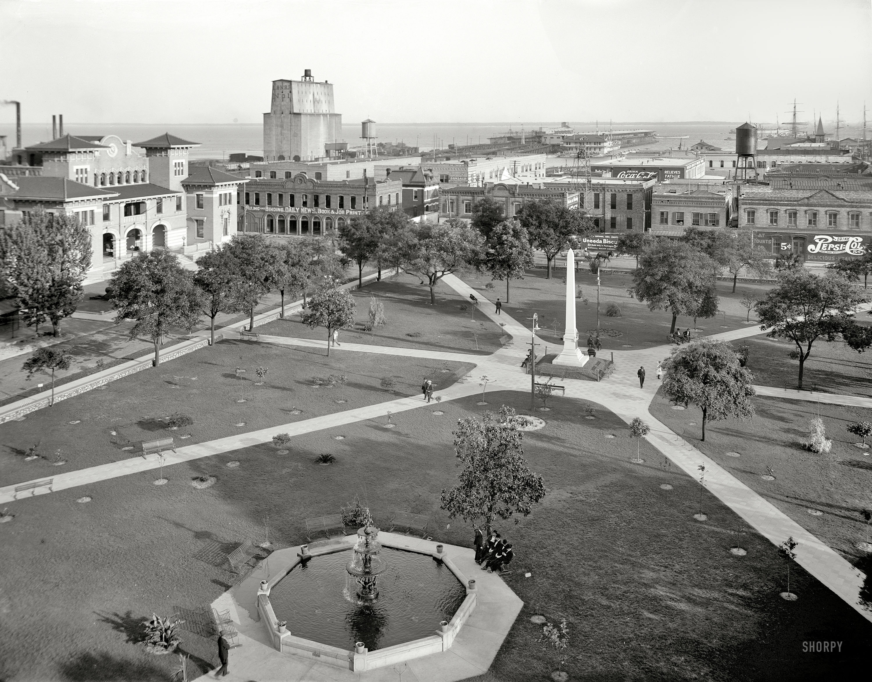 Pensacola, Florida, circa 1910. "Plaza Ferdinand and harbor." Brought to you by Coca-Cola, Pepsi and Uneeda Biscuit. 8x10 glass negative. View full size.
