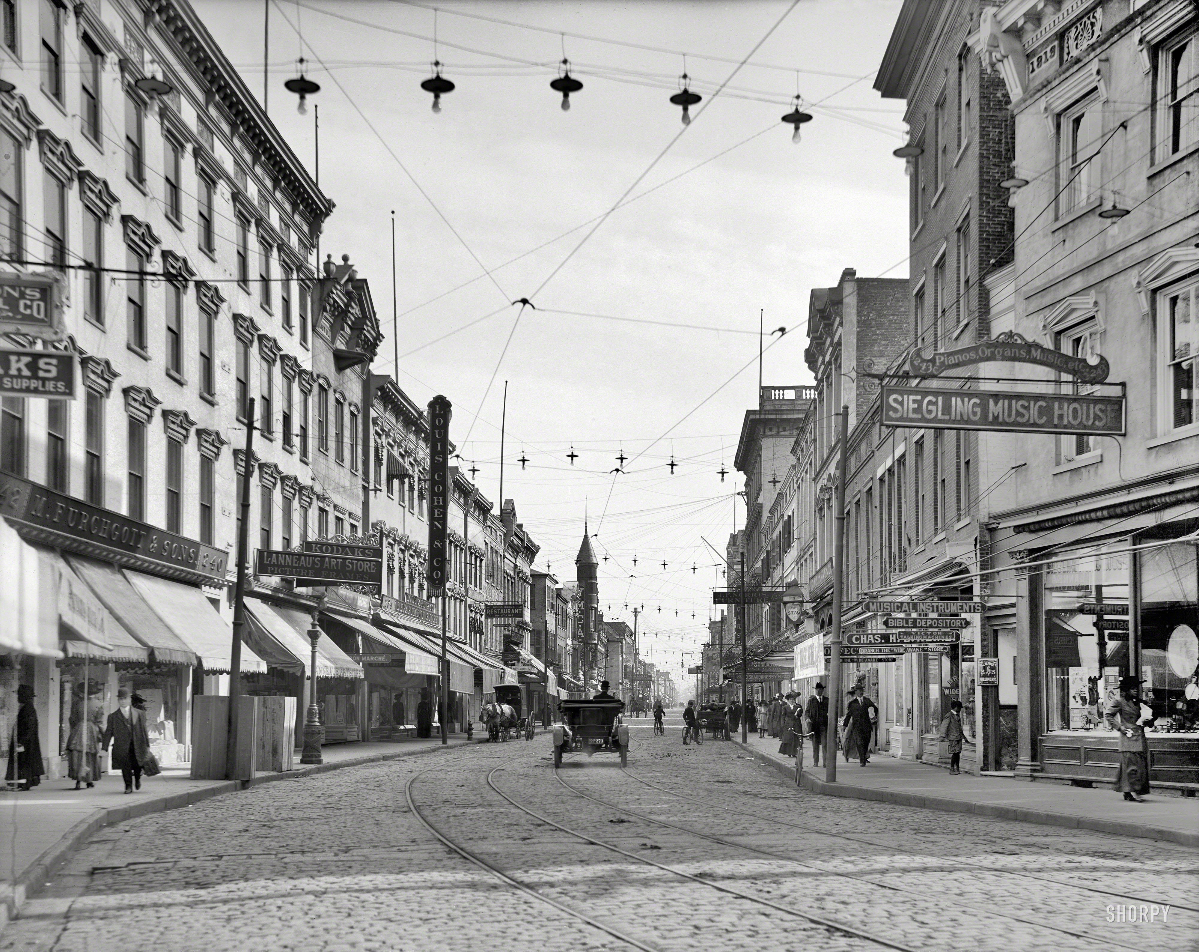 Charleston, South Carolina, circa 1910. "King Street, south." Among the merch&shy;ants vying for your trade are a Bible depository, Victor Talking Machines dealer and branch of the "Wide Awake" store. 8x10 inch glass negative. View full size.
