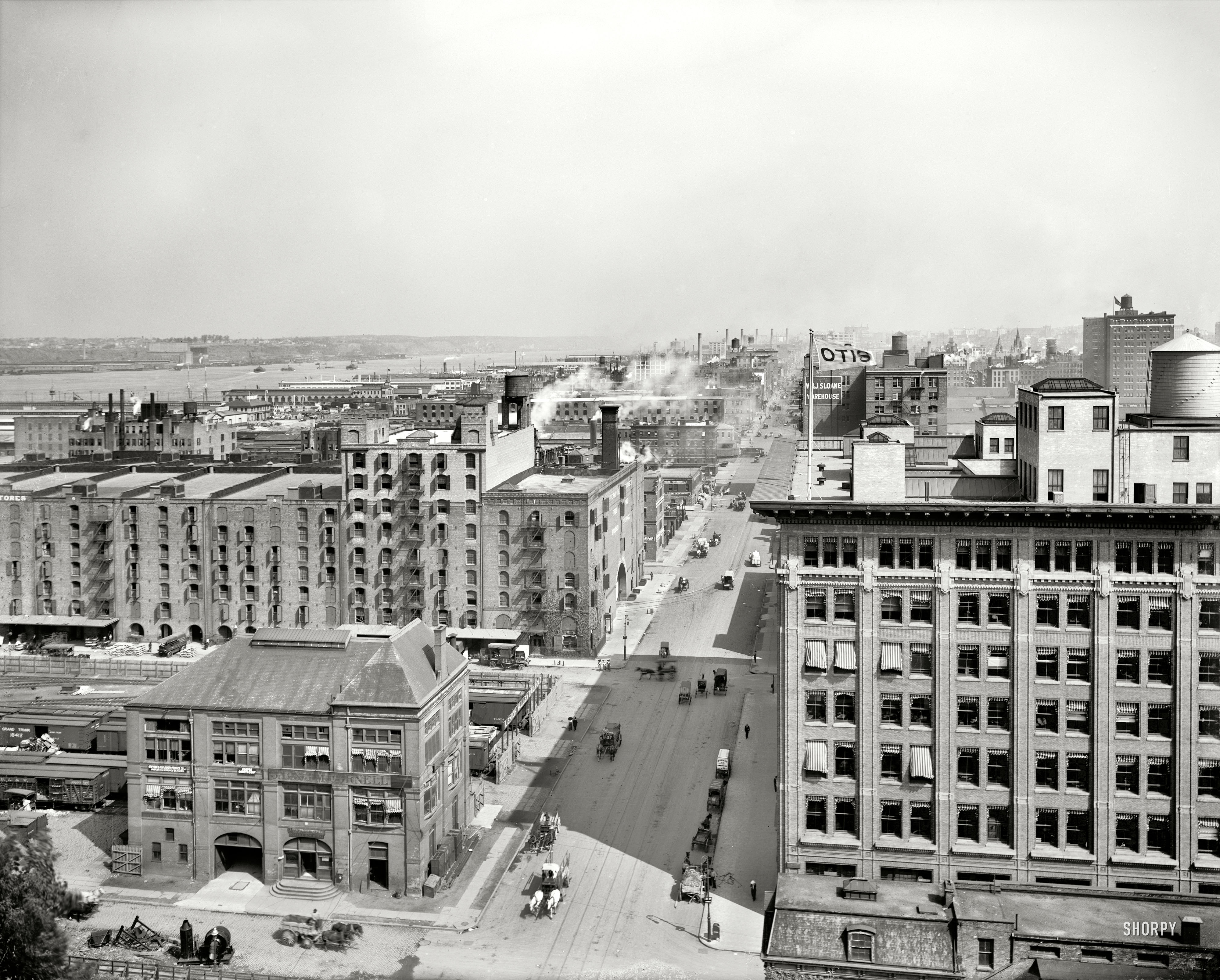 New York circa 1912. "West Street (11th Avenue) north from 26th, view of  Hudson River." As well as the Chelsea Piers and fluttering banner atop the Otis Elevator building. 8x10 glass negative, Detroit Publishing Co. View full size.