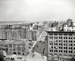 New York circa 1912. "West Street (11th Avenue) north from 26th, view of  Hudson River." As well as the Chelsea Piers and fluttering banner atop the Otis Elevator building. 8x10 glass negative, Detroit Publishing Co. View full size.
W&amp;J Sloane WarehouseThe W&amp;J Sloane  Company was a high-end home furnishing business. Established in 1843, they filed for bankruptcy protection in 1985. Their retail store was at 888 Broadway, at 18th Street, now home to ABC Carpeting, a similar business. This area was known as the "Ladies Mile" district it had many stores catering to the well-to-do. Sloane eventually moved to the even more exclusive 5th Avenue.
Strange piece of machineryI'm really curious as to what this device is in the lower left.
It looks like a giant Vacuum Cleaner?
Night MarchThe notorious reputation of "Death Avenue" for fatal train accidents has been mentioned here before.  An extraordinary event occurred on the night of October 24, 1908, when 500 schoolchildren marched down the avenue, "carrying American badges and flags draped in mourning," to protest the death of 7-year-old Seth Low Hascamp.   The boy had been "ground to death" the month before, when he fell off the top of a freight car at 11th and West 35th during a game of Follow-the-Leader. 
Ups and downsThe Otis building is still there!
Buck buck.I love the small details in these photos.  In this one, unloading or more likely cleaning up the carcasses from a poultry car in the lower left corner.
Nary an automobile in sight.But there is a steam dummy crossing the avenue just past the Otis building. Steam dummies were locomotives disguised with car bodies so as not to alarm horses.
[There's an automobile just a few feet away. - Dave]
And I, evidently, need new glasses!
Cement MixerPutti; putti...
 The Strange Device is, I believe, a skid-mounted (hence portable, sort of) steam-operated cement mixer.  The large dark vertical cylinder is the boiler, the engine - also vertical - can be be seen to the right of it, and the big barrel is the mixer itself with its delivery chute facing us.
Now, back to Pico and Sepulveda.
Otis Elevator BuildingThe history of Otis Elevator and its headquarters building can be found in West Chelsea Historic District pages 81 to 84.
Re: Cement MixerTahoePines, you are correct, thank you.
Knowing what it is I was able to find this illustration (or really grainy photograph?) of a similar machine.
Cornell Iron Works still in the worksSometimes searching the names of the old firms in the wonderful Shorpy photos yields surprises.  Cornell Iron Works is still going and the in depth historical information on its website mentions this location on the far side of the cement mixer.
Terminal Warehouse!Still there, looks relatively untouched:
View Larger Map
I'm pretty jazzed about that.
A little place for my stuffThe Terminal Warehouse is today partially occupied by a "mini-storage" facility. I kept the excess stuff that I, for some unknown reason, owned that didn't fit in my Manhattan apartment there for a couple of years (until I could finally afford a bigger place to live). Very interesting cast of characters hanging around that place, including some well-known musicians who used their storage rooms as practice spaces, which definitely brightened up the otherwise dreary surroundings.
(The Gallery, Boats & Bridges, DPC, NYC, Railroads)