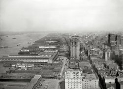 New York circa 1912. "West Street north from the Battery." An amazing view of the Hudson River piers from the foot of Manhattan centered by the West Street Building, which sustained grave damage a decade ago when the south tower of the World Trade Center collapsed; to east is the massive Hudson Terminal, and faintly visible through the haze is the Metropolitan Life tower. Note the ant-like profusion of horse wagons along West Street. This 8x10 glass negative was exposed from the Whitehall Building annex just south of today's Battery Park City and World Financial Center. The view up West Street and 11th Avenue is continued here at the Chelsea Piers. Detroit Publishing Co. View full size.
Best of the BestThis photo will become my "forever" all time favorite.  It evokes history at so many levels.  Amazingly, the two bridges that cross West Street are in extreme close proximity to those that connected the World Trade Center to The  World Financial Center at Battery Park City.  Actually the northern one looks like it is in exactly the same place!  All I can do is stare and marvel at this gem that we are lucky enough to view.  Thanks Dave/Shorpy
West Street BuildingIt is absolutely incredible to see the West Street Building standing in so isolated a position - yet it is barely a quarter-mile away from Broadway! Such were the contours of real estate values in Lower Manhattan a century ago. The West Street Building (1906-1907) was designed by Cass Gilbert; as his first "Gothic" skyscraper, it became the model for his more famous Woolworth Building of 1911-1913. It is believed that Frank W. Woolworth chose Gilbert as his architect largely because he liked what he saw on West Street.
!!Anazing.
[Jawohl. - Dave]
Whitehall StreetA few personal things come to mind when I read that The Whitehall Building was where this magnificent 1912 photo was taken. First, 39 Whitehall Street, was the building where I, and probably a million others were inducted into the US Army. The date I was there, October 8, 1956 and another momentous event was happening at the World Series in Yankee Stadium, Don Larsen pitched a perfect game.
Fast forward to 1995 and my wife and I are at the Whitehall Building looking at the Whitehall Club as a venue for my youngest daughter's wedding. The club occupied the entire top floor of the building with unobstructed views in all 4 directions. The views of the city, the Hudson River and the Statue of Liberty were just amazing. We didn't use that setting, because on a Saturday night, that part of town is usually deserted.
A REAL SeaportThis is wonderful evidence that, indeed, NY was once a great seaport. Look at all the piers with so much activity!
Fall River Line Steamers?The two large steamboats appear to be Fall River Line steamers. Up until 1937, the night boats of the Fall River Line were the preferred way to travel between NYC and Boston.  A "boat train" met the boat in Fall River, MA early each morning. 
Can anyone identify these steamboats? The far one seems to me to be the "Commonwealth".
(The Gallery, Boats & Bridges, DPC, NYC)