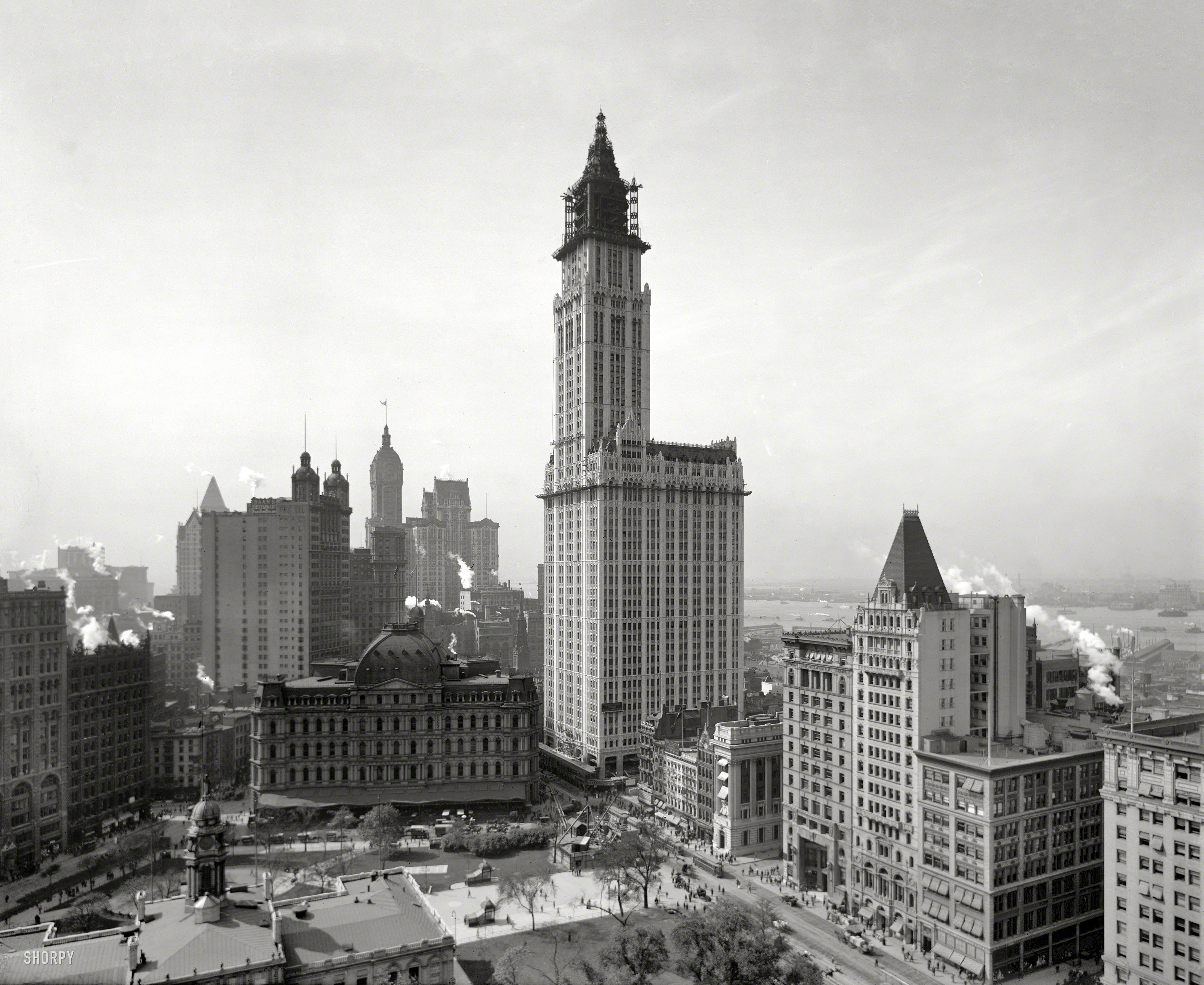 The Woolworth Building under construction in 1912. One hundred years later, the top 30 floors of the former department store headquarters are being converted to 40 luxury apartments, with a five-story penthouse in the cupola. Other New York landmarks in this view include City Hall Park and its post office, as well as the Singer and Park Row towers. 8x10 glass negative. View full size.