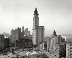 The Woolworth Building under construction in 1912. One hundred years later, the top 30 floors of the former department store headquarters are being converted to 40 luxury apartments, with a five-story penthouse in the cupola. Other New York landmarks in this view include City Hall Park and its post office, as well as the Singer and Park Row towers. 8x10 glass negative. View full size.
I&#039;ll Never Live There!From: www.gothamist.com:
And suddenly, those fancy $100 million apartments on 57th Street look positively quaint. Because BOOM, whoever gets the penthouse apartment in the now-officially-going-residential Woolworth Building clearly wins at New York real estate. Hands down. 
After years of rumor and speculation, the Witkoff Group and Cammeby have sold the top 30 floors of the iconic tower to an investment group led by Alchemy Properties with the intention that they will turn it into apartments (the lower 28 floors will be leased as office space). And oh, sweet Peter Stuyvesant, we want to go to there:
Penthouses in the building once called the “Cathedral of Commerce” will be among the highest-altitude residences in the city, soaring above 700 feet. A five-level penthouse of around 8,000 square feet will be housed in the copper-clad cupola that tops out at 792 feet. Originally designed as a public observation area, the cupola has a wraparound outdoor deck reached by a private elevator.
Apartments will begin at 350 feet above ground level, with panoramic views and 11'-14' ceiling heights, when they are completed (in theory by 2015). Oh and that is not all. The $150 million conversion (which includes the $68 million purchase price) will also include restoring the 55-foot-long basement swimming pool for the residents. And, and, and... ugh, anybody want to go halfsies—or, more realistically, fiftysies? We could handle going SRO in that building—on one of those apartments with us? They are estimated to go for only about $3,000 per square foot. 
Changing ManhattanPre 9/11 the Woolworth building folks were never the friendliest lot.  Looks like Verizon is going the same route.  Verizon has announced plans to sell/lease the majority of 140 West Street (another persona not grata lobby) for residential use.  It has a lobby that comes close to the Woolworth's.
The worst building management anywhereThe management company that operates the building today is the target of much dislike, if not outright hatred.  They refuse to let anyone see the beautiful lobby, posting "No tourists allowed" signs at the entrances along with scowling guards.  All this despite the fact that as a landmark there is supposed to be public access to the lobby.
I was in the &quot;penthouse&quot;We used to go on "building adventures" before the high security in office lobbies took effect back in the 80s and found our way to the top of some of these old classics.  I remember finding that staircase which went to the very top of the Woolworth Building and looking out those windows, was awesome.
If OnlyI don't know about the rest of you, but I would love to live at the top of the Woolworth Building. 
Why did the West Side never develop?I've never understood why Broadway was utterly lined with tall buildings but everything west of Church is short. Why did no one buy the land a few blocks west of the area from City Hall down to Wall Street and build tall structures there?
(The Gallery, DPC, NYC)