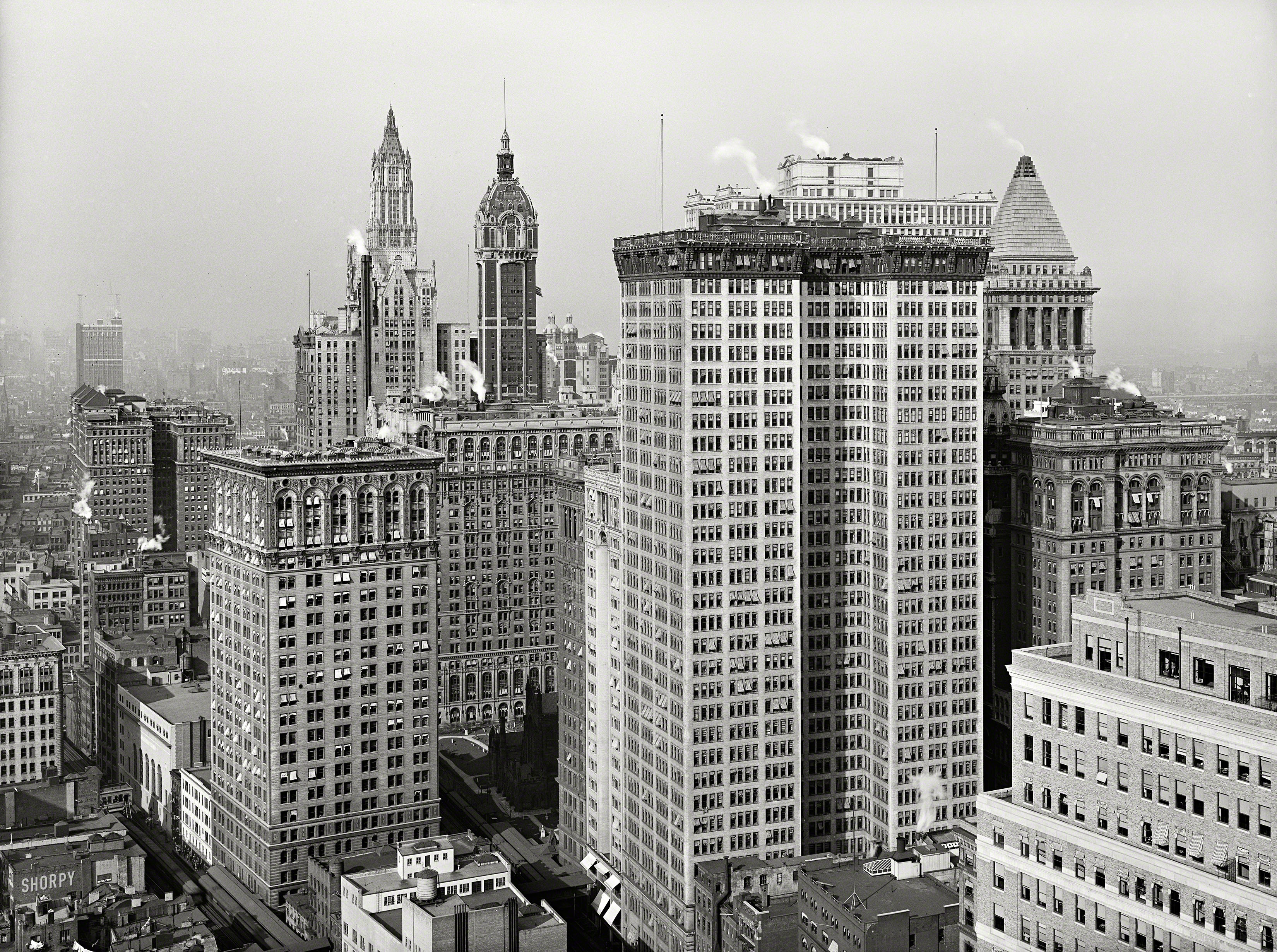 New York circa 1917. "Skyscrapers, looking north toward towers of Woolworth and Singer buildings." Double-barreled tower in the foreground is the Adams Express Building. 5x7 inch glass negative, Detroit Publishing Co. View full size.