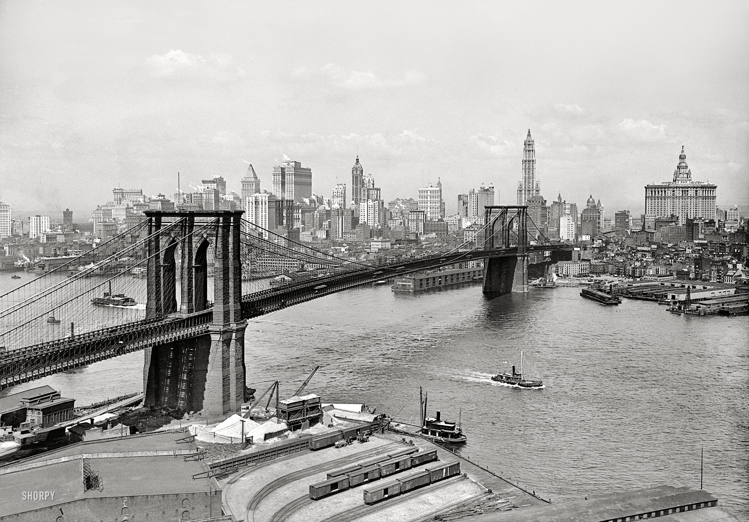 New York circa 1915. "Brooklyn Bridge, East River and skyline." The Woolworth Building stars in this Lower Manhattan view, with the Singer, Bankers Trust, Hudson Terminal, Municipal and Park Row buildings as understudies. 5x7 inch dry plate glass negative, Detroit Publishing Company. View full size.