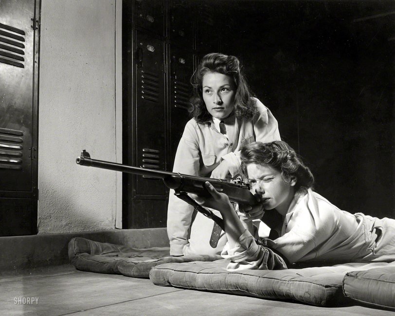 August 1942. "Training in marksmanship helps girls at Roosevelt High School in Los Angeles develop into responsible women. Part of Victory Corps activities there, rifle practice encourages girls to be accurate in handling firearms. Practicing on the rifle range in the school's basement." Large format acetate negative by Alfred Palmer for the Office of War Information. View full size.
