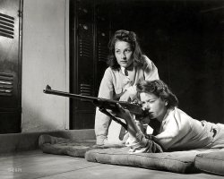 August 1942. "Training in marksmanship helps girls at Roosevelt High School in Los Angeles develop into responsible women. Part of Victory Corps activities there, rifle practice encourages girls to be accurate in handling firearms. Practicing on the rifle range in the school's basement." Large format acetate negative by Alfred Palmer for the Office of War Information. View full size.