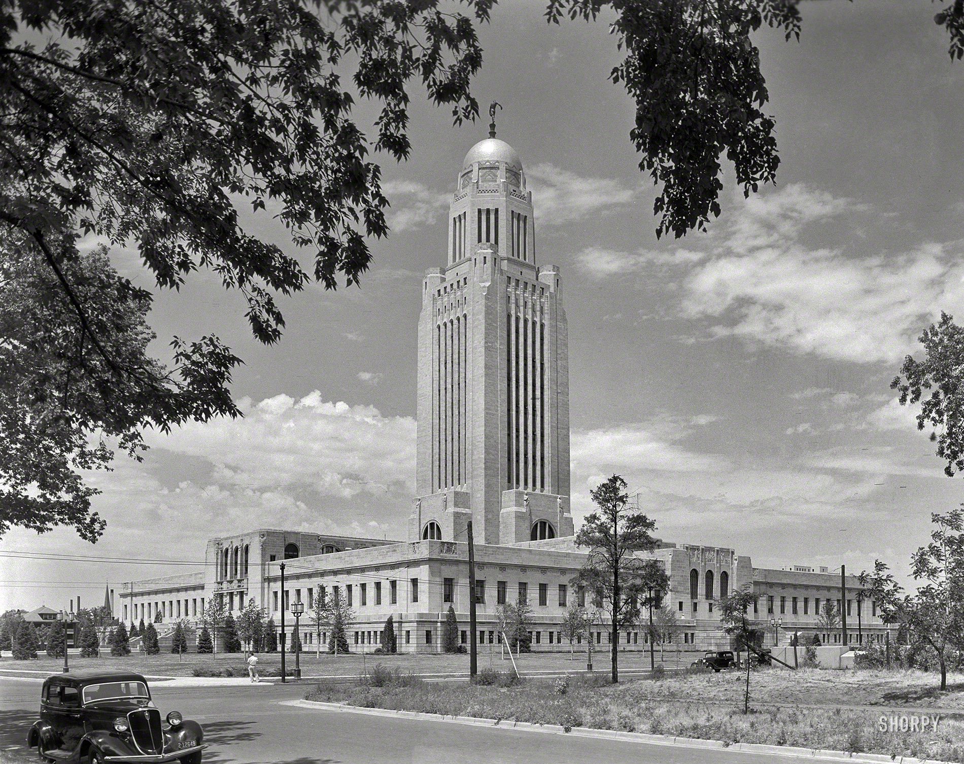 June 1934. "Nebraska State Capitol, Lincoln. General view from southeast. Mayers, Murray & Phillip, successor architects to Bertram Goodhue." We had a bowling trophy that looked a lot like this. Gottscho-Schleisner photo. View full size.