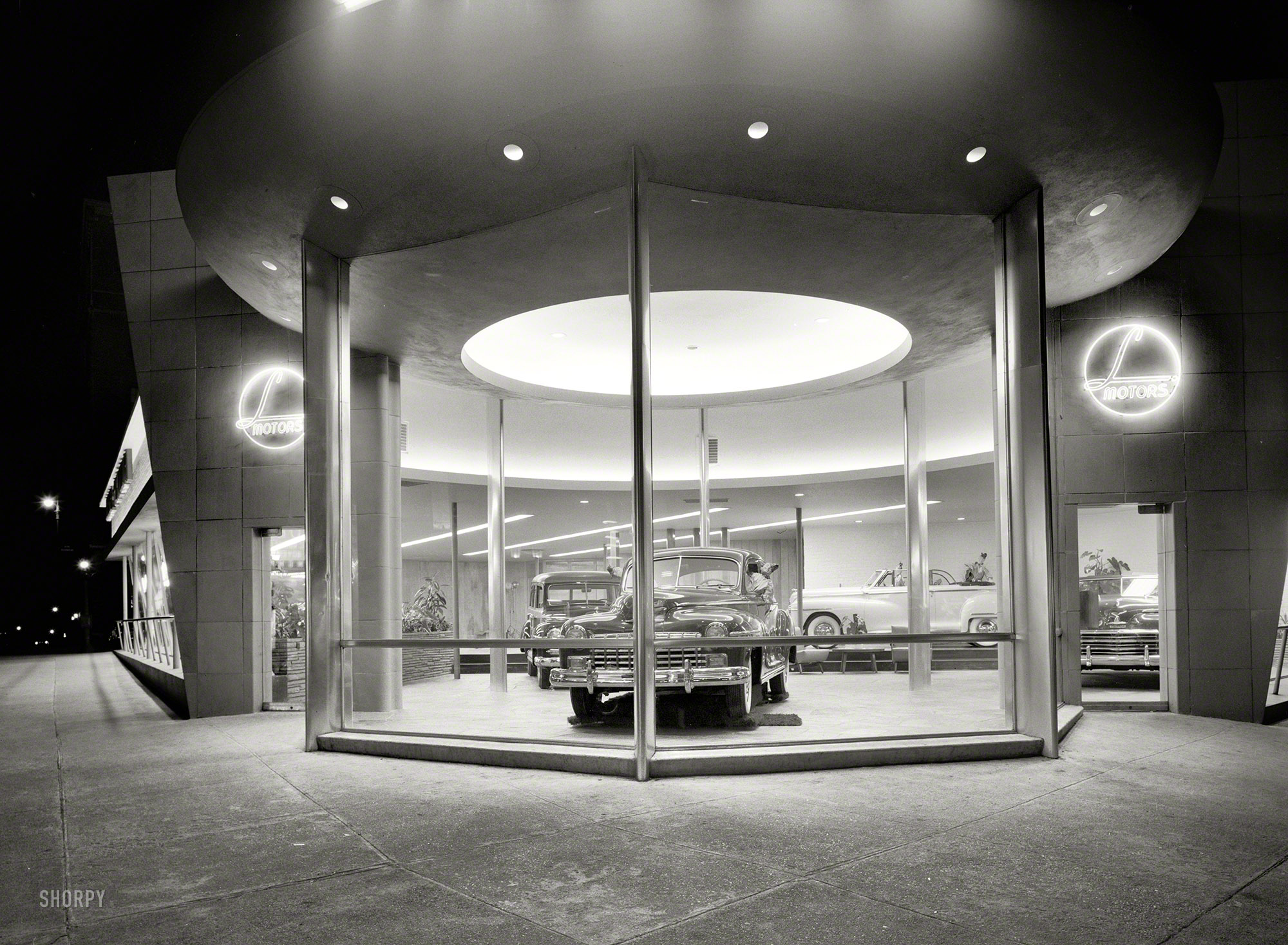 March 24, 1948. "L Motors, 175th Street and Broadway, New York City. Entrance detail." Our second look at this showroom and its curious display of dummies in Dodges. Large-format acetate negative by Gottscho-Schleisner. View full size.