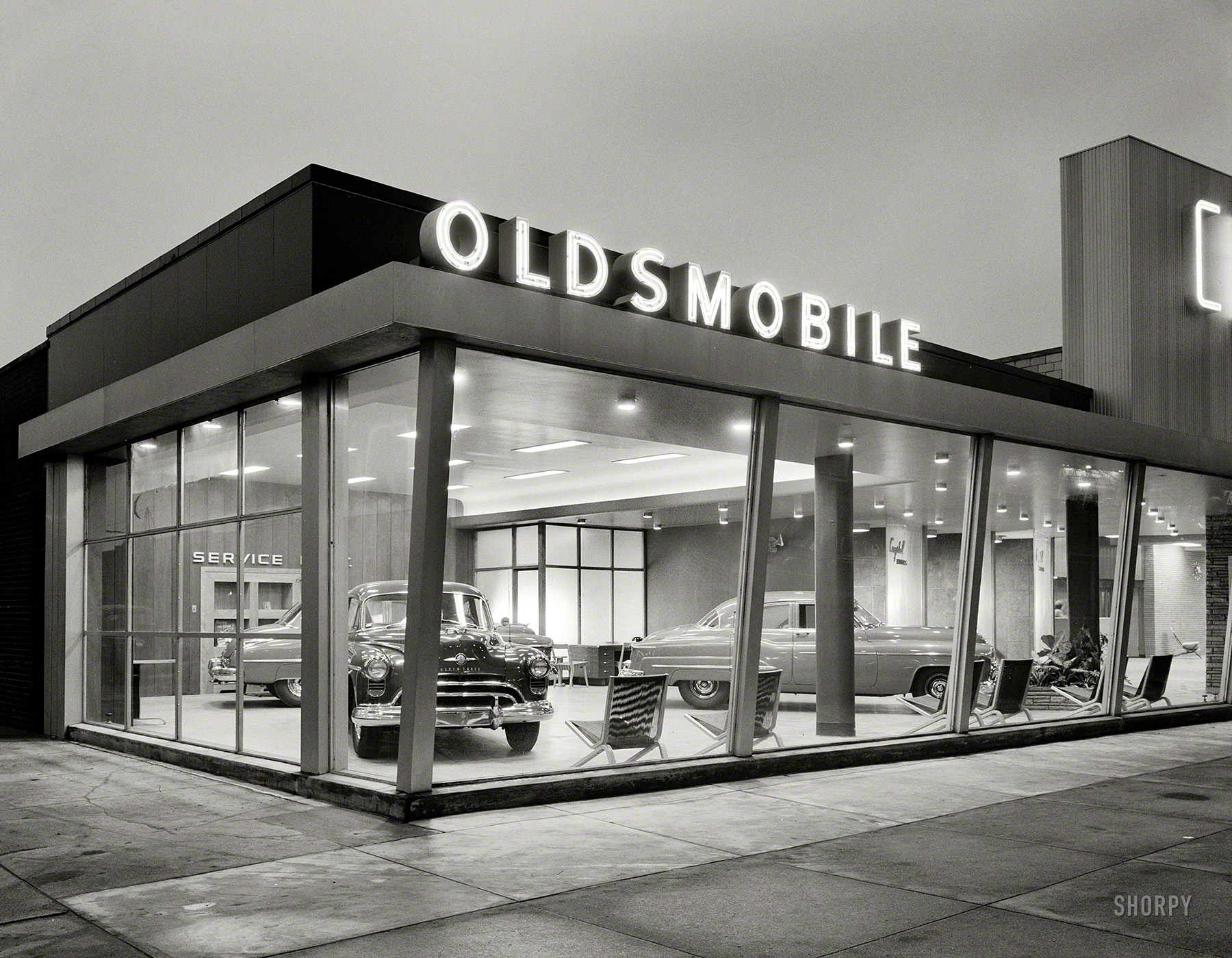 February 15, 1950. New York. "Crystal Motors, business at 5901 Bay Parkway, Brooklyn. Exterior II." On display: the "Futuramic" 1950 Oldsmobile. Large-format acetate negative by Gottscho-Schleisner. View full size.