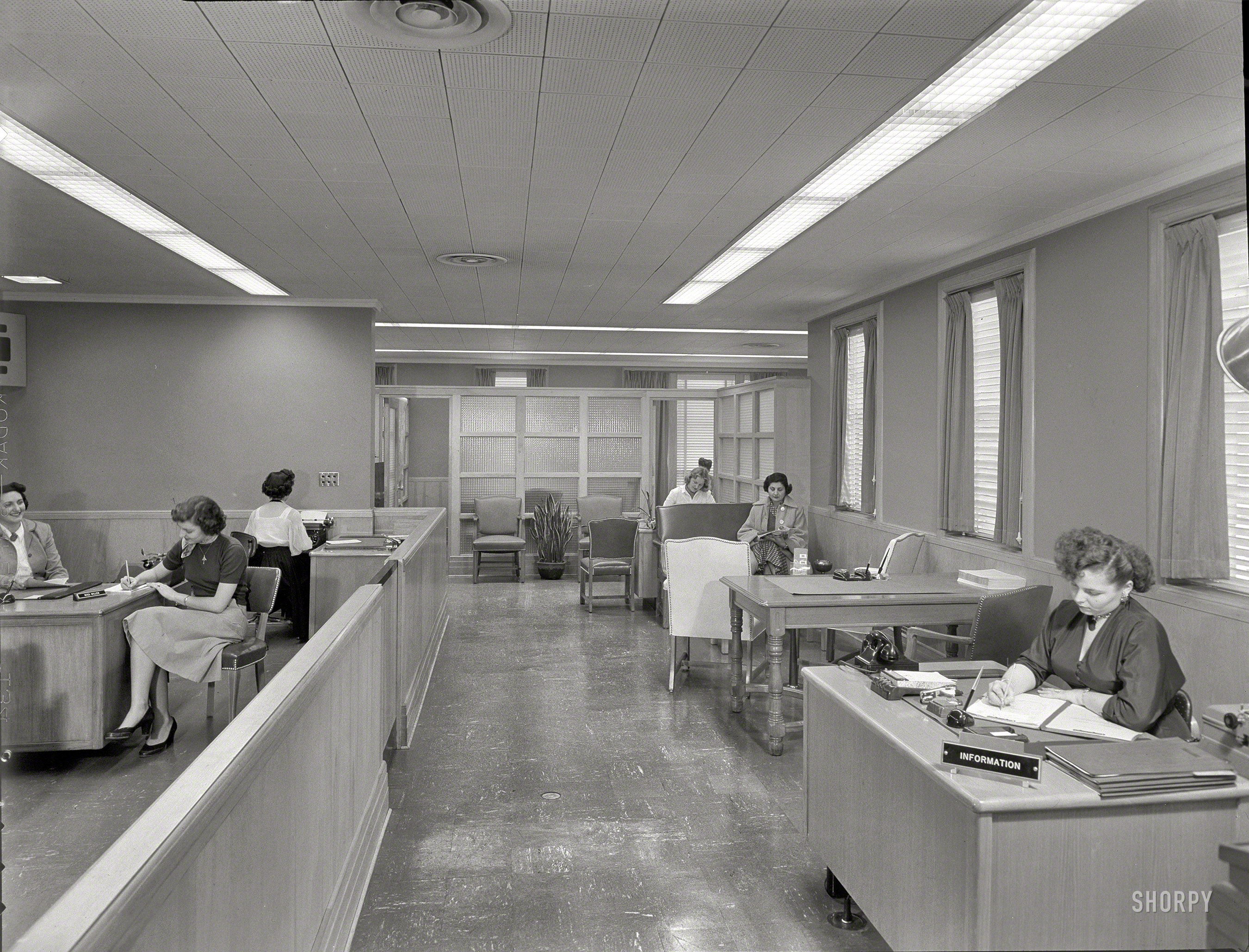 February 24, 1953. "Suffolk County Federal Savings. Babylon, Long Island, New York. Mortgage room. C.M. Johnson, client." At left, Miss Miller; at right, Miss Information. Large-format negative by Gottscho-Schleisner. View full size.