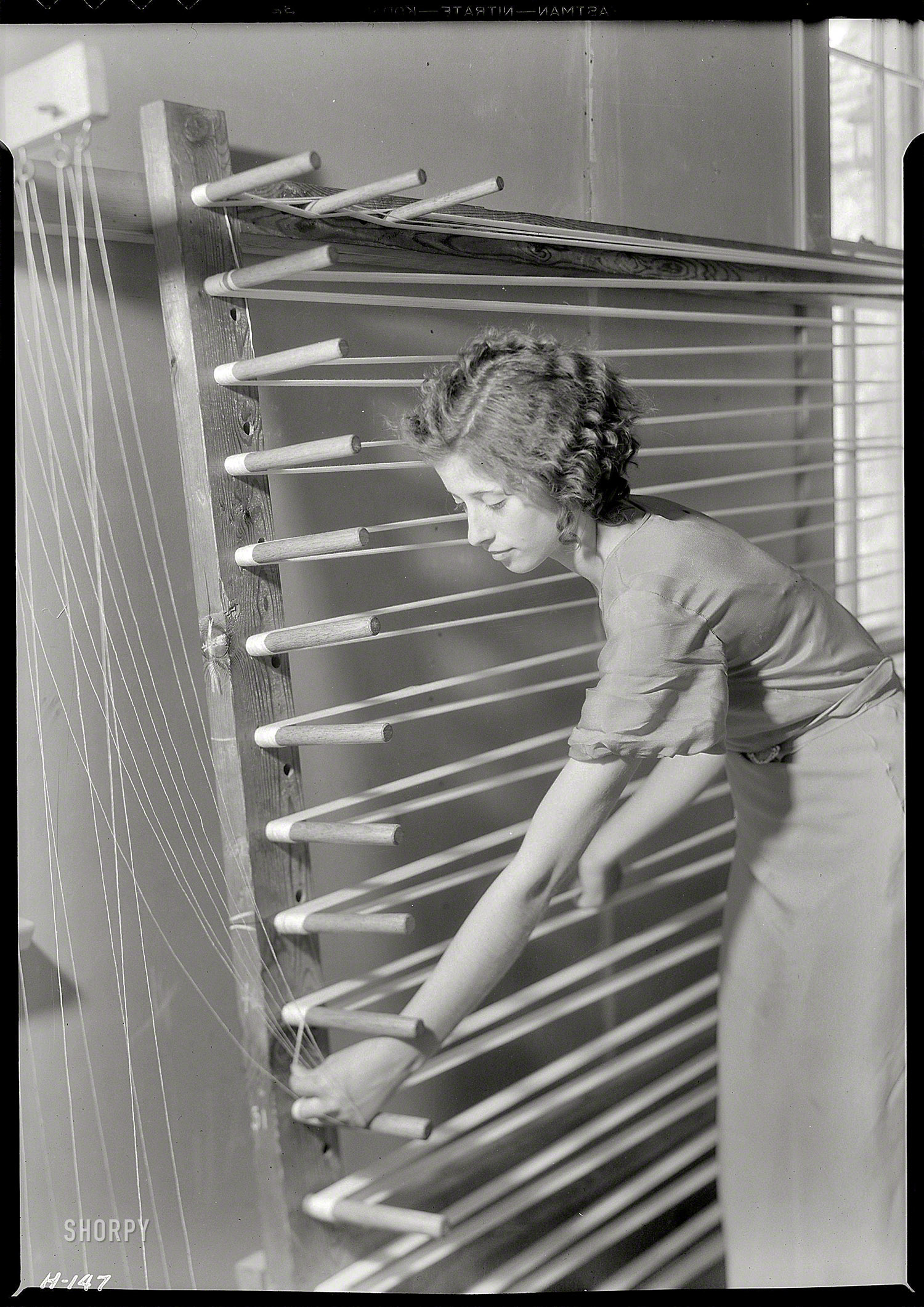 November 1933. Gatlinburg, Tennessee. "Beulah Ogle preparing warp for weaving at the Pi Beta Phi School. She is a new weaver at the school and lives on a mountain farm." Another example of Lewis Hine's post-newsie oeuvre. Large format nitrate negative, National Archives. View full size.