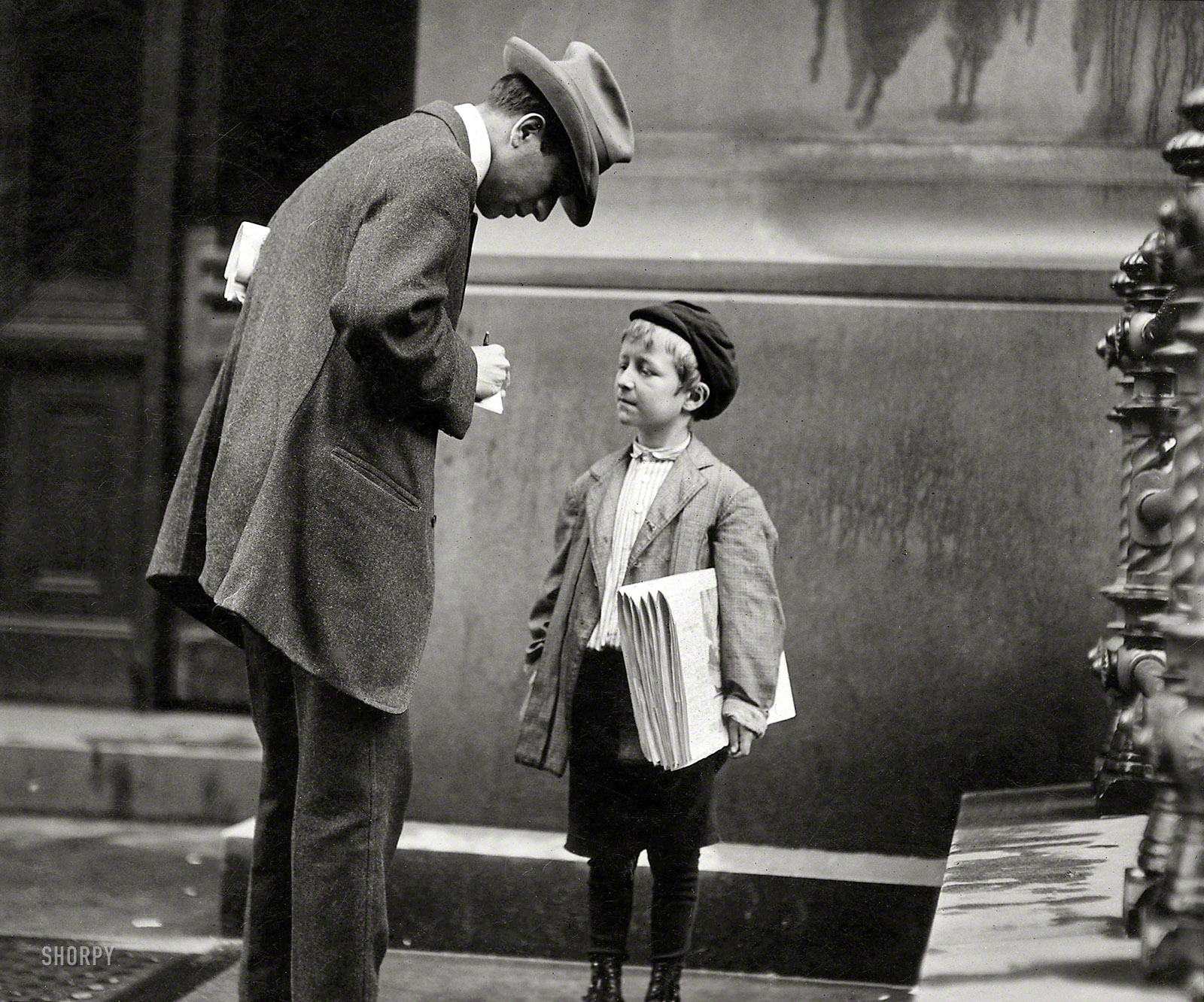 June 1910. Philadelphia, Pa. "Michael McNelis, 8 years old, a newsboy. This boy has just recovered from his second attack of pneumonia. Was found selling papers in a big rainstorm today." Photo by Lewis Wickes Hine. View full size.