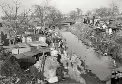 March 1937. Paterson, New Jersey. "Textiles. Bachelor shacks in outskirts of Paterson, on Molly Jan Brook. About 25 men live here now (some of them old silk workers) and stay here all winter. Man in one view worked in silk up to 5 years ago. On relief now." Photo by Lewis Wickes Hine. View full size.