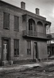 Circa 1920. "Two-story houses, New Orleans." One of the Crescent City's grittier, grainier corners. 4x5 nitrate negative by Arnold Genthe. View full size.