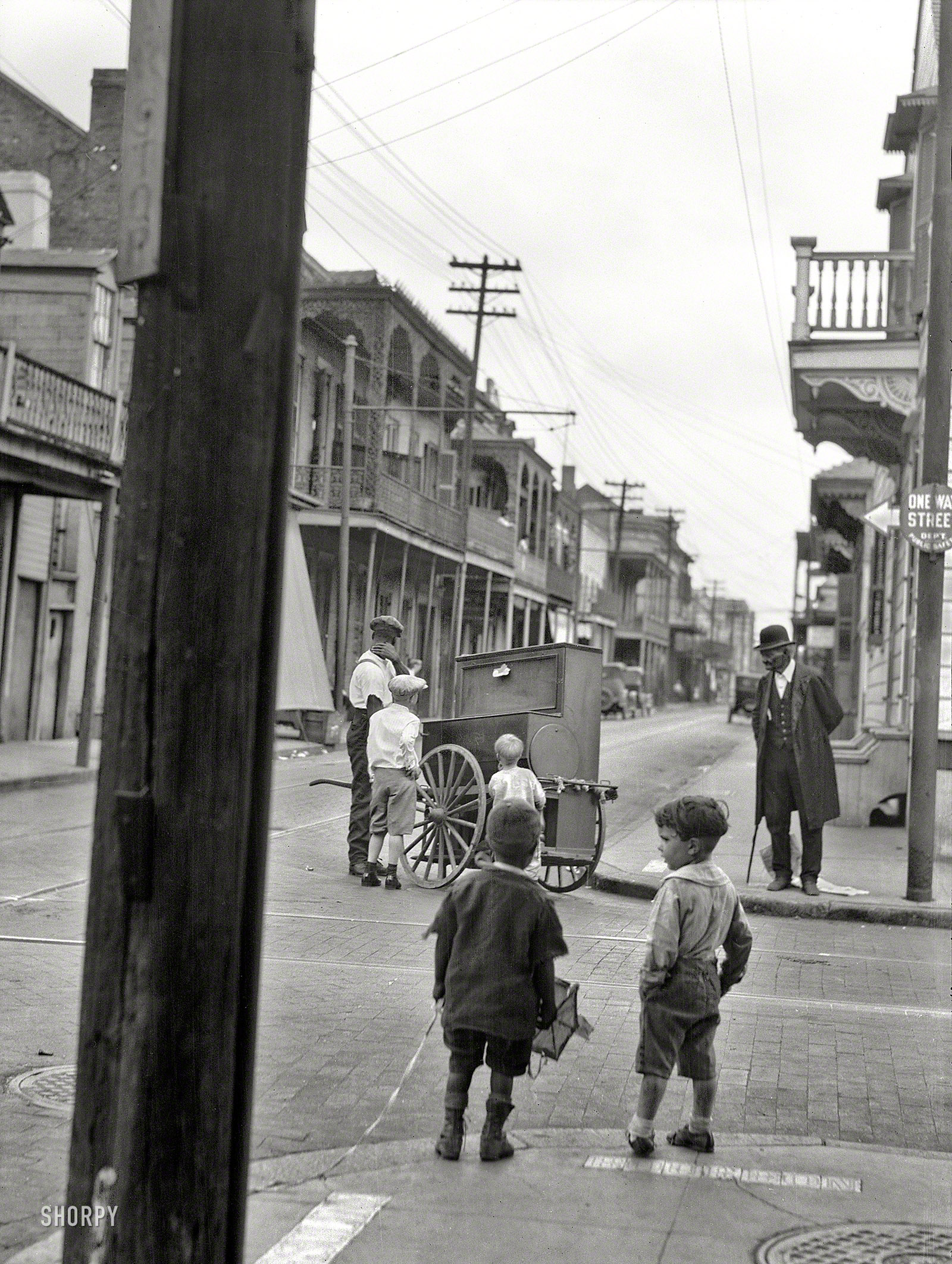 Bourbon Street and Ursulines Avenue circa 1924. "New Orleans organ grinder." Nitrate negative by Arnold Genthe. View full size.