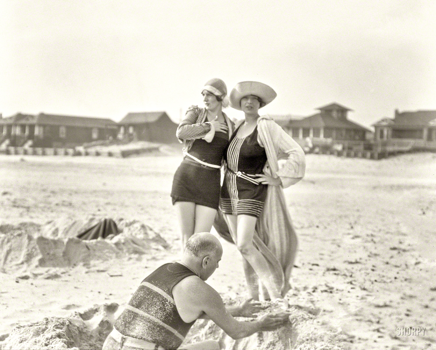Circa 1920s. "Man building sand castle and two unidentified women. Long Beach, New York." 4x5 nitrate negative by Arnold Genthe. View full size.