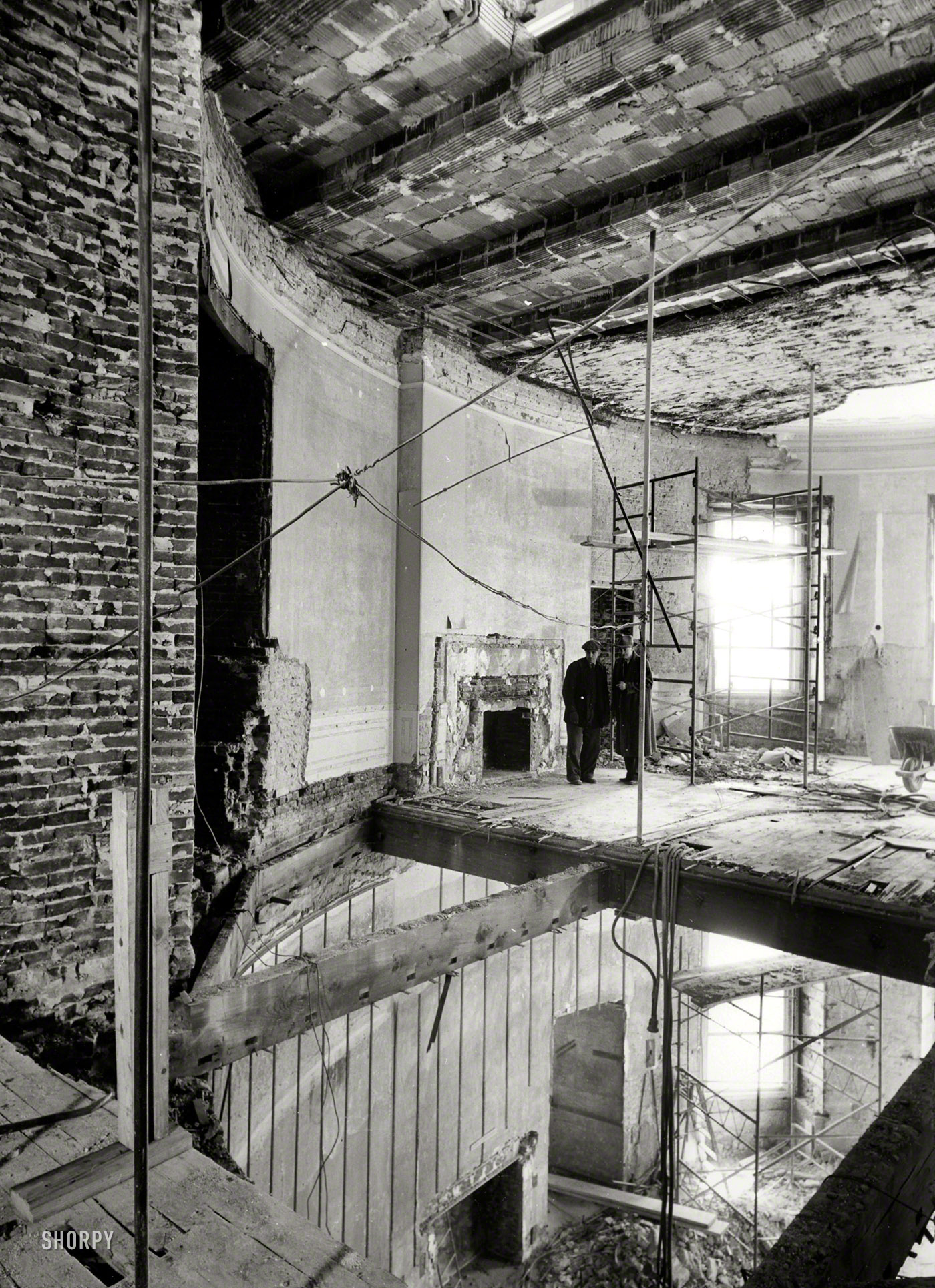 March 9, 1950. Washington, D.C . "White House renovation. Second floor Oval Study above Blue Room. North wall and part of floor removed for installation of steel shoring columns." Photo by Abbie Rowe. View full size.