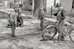 May 1940. "Boys playing marbles. Woodbine, Iowa." 35mm nitrate negative by John Vachon for the Farm Security Administration. View full size.