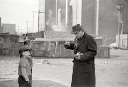 FSA photographer Arthur Rothstein somewhere in St. Louis with two young subjects in an uncaptioned exposure from January 1939. ("Hey Mister, got a light?" "No, Sonny, but I have a light meter.") 35mm negative. View full size. 