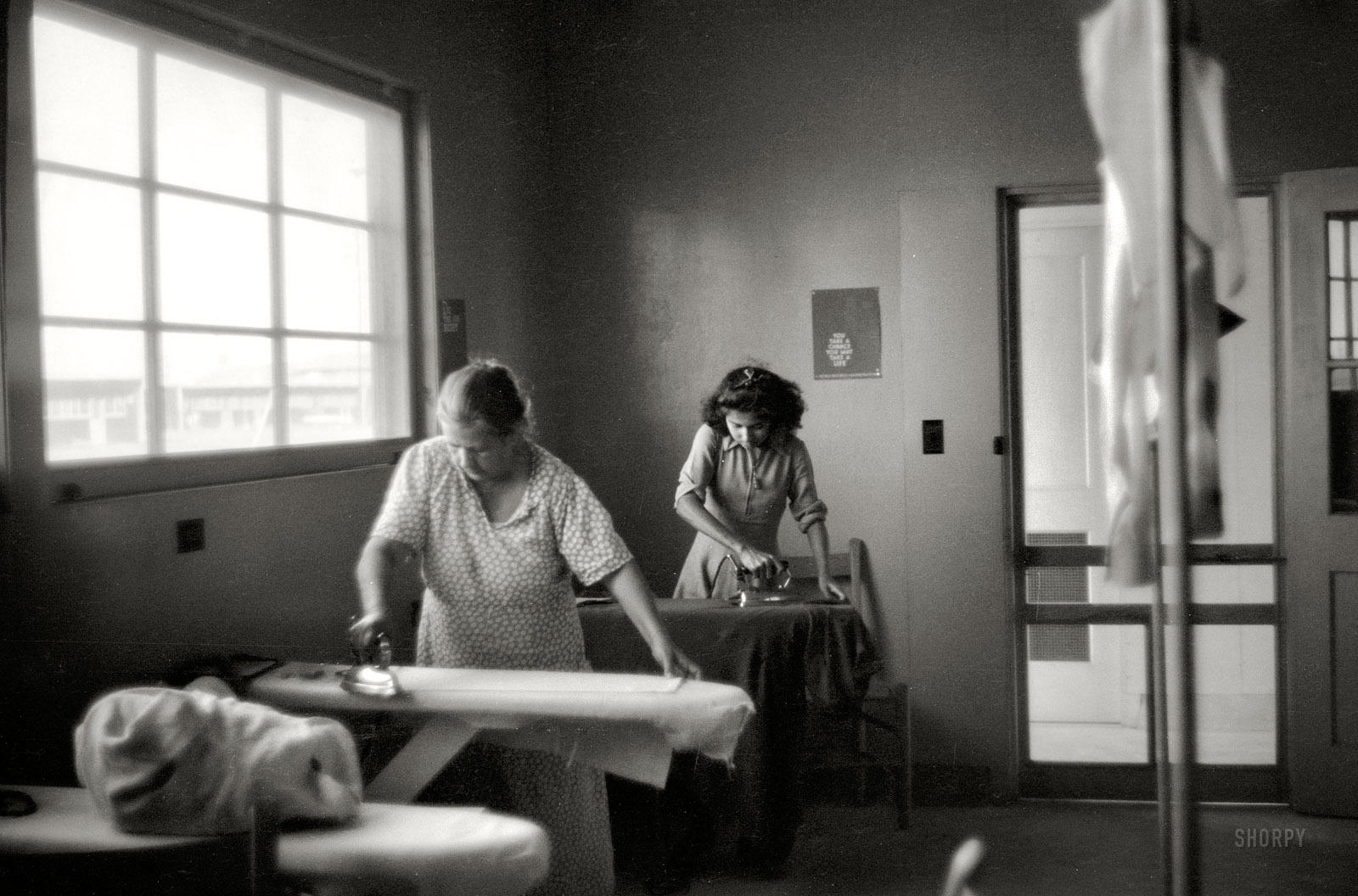 March 1940. "Ironing room at FSA migratory labor camp at Sinton, Texas." 35mm negative by Russell Lee for the Farm Security Administration. View full size.
