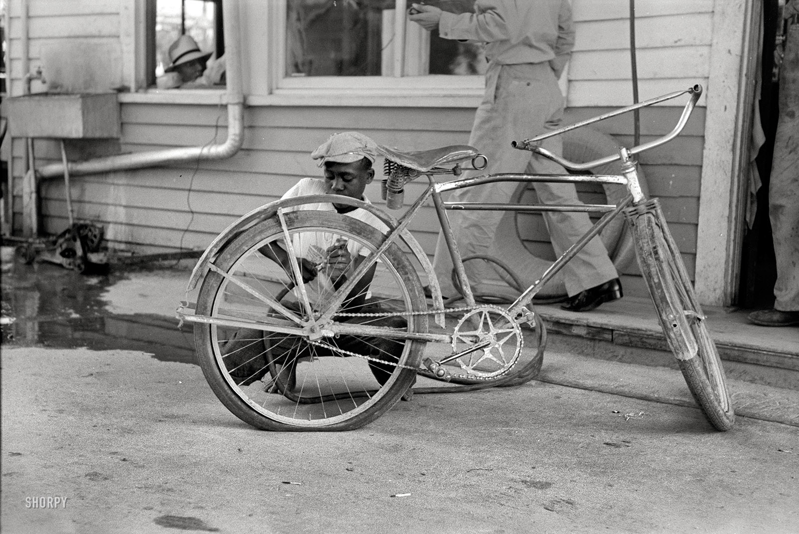 September 1938. "Inflating bicycle tire in Abbeville, Louisiana." 35mm nitrate negative by Russell Lee for the Farm Security Administration. View full size.