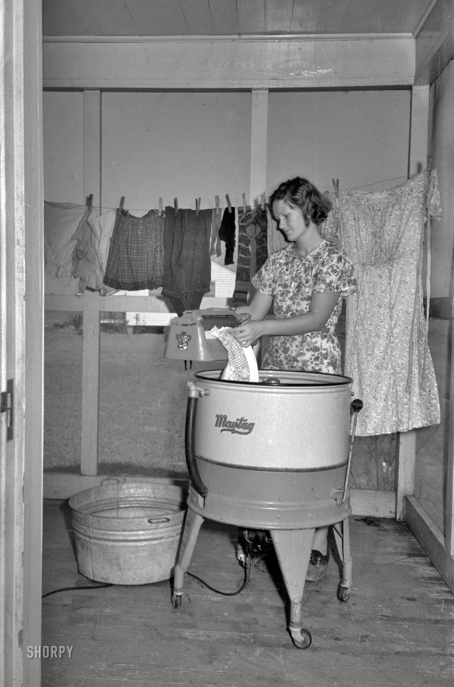 September 1938. "Farm wife washing clothes. Lake Dick Project, Arkansas." 35mm negative by Russell Lee, Farm Security Administration. View full size.